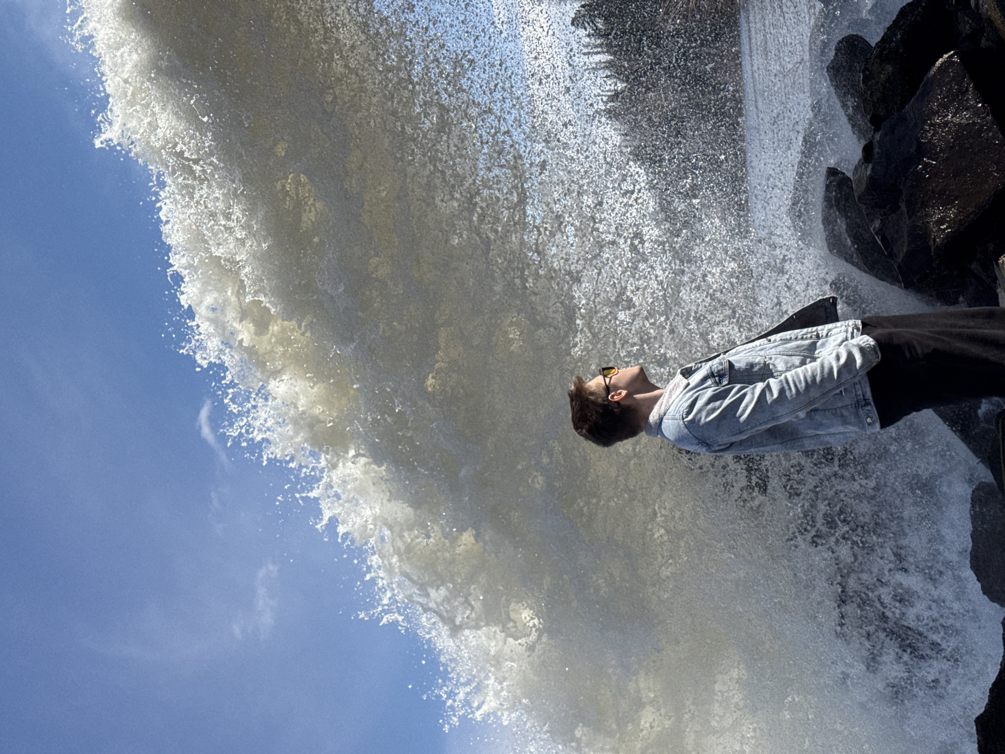 Young man photographed at waterfall in Chernushka, Russia