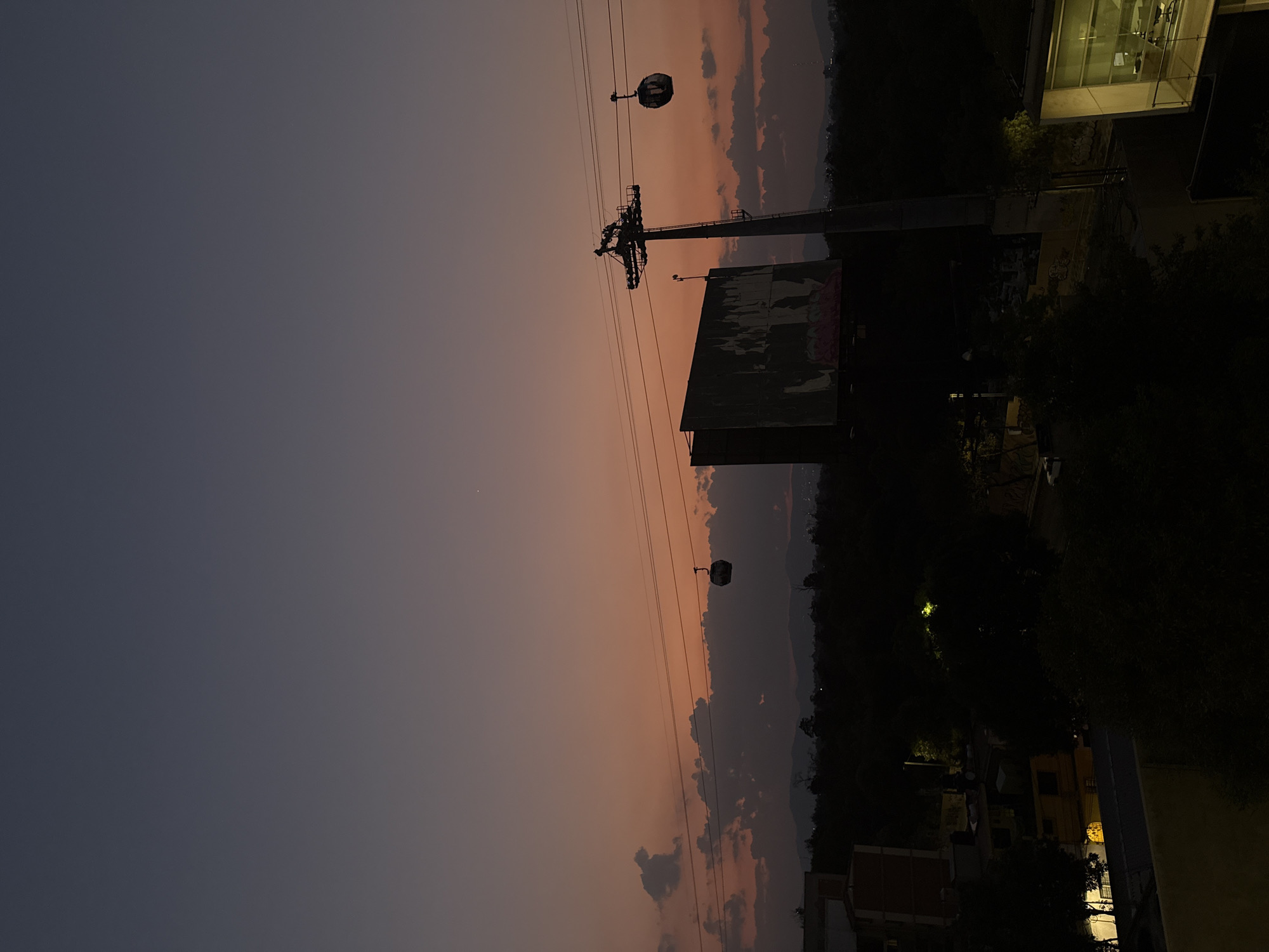 Mexico City nighttime skyline captured with cable car system visible