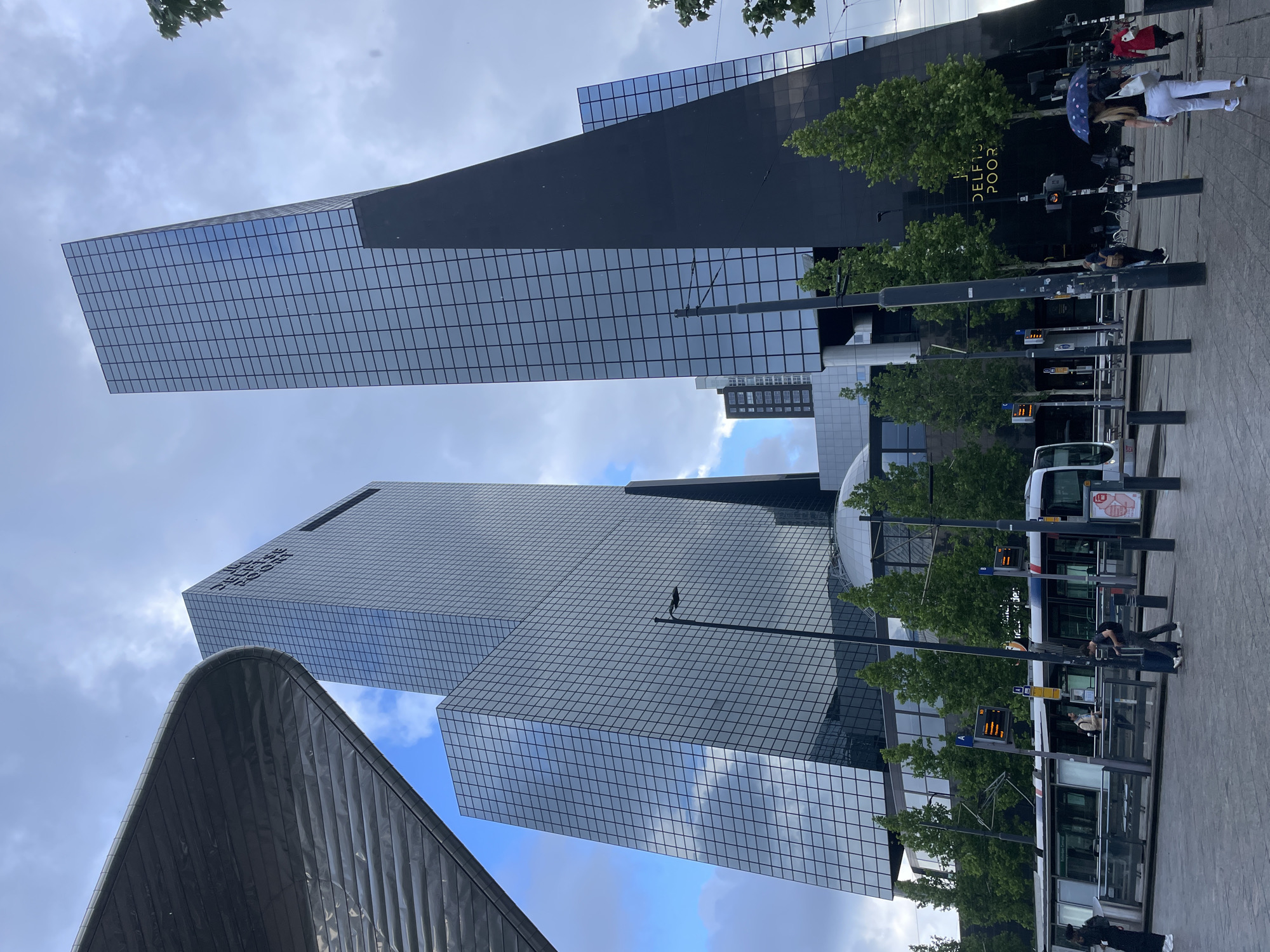 Morning urban documentation captures Rotterdam's modern architecture and streetlife