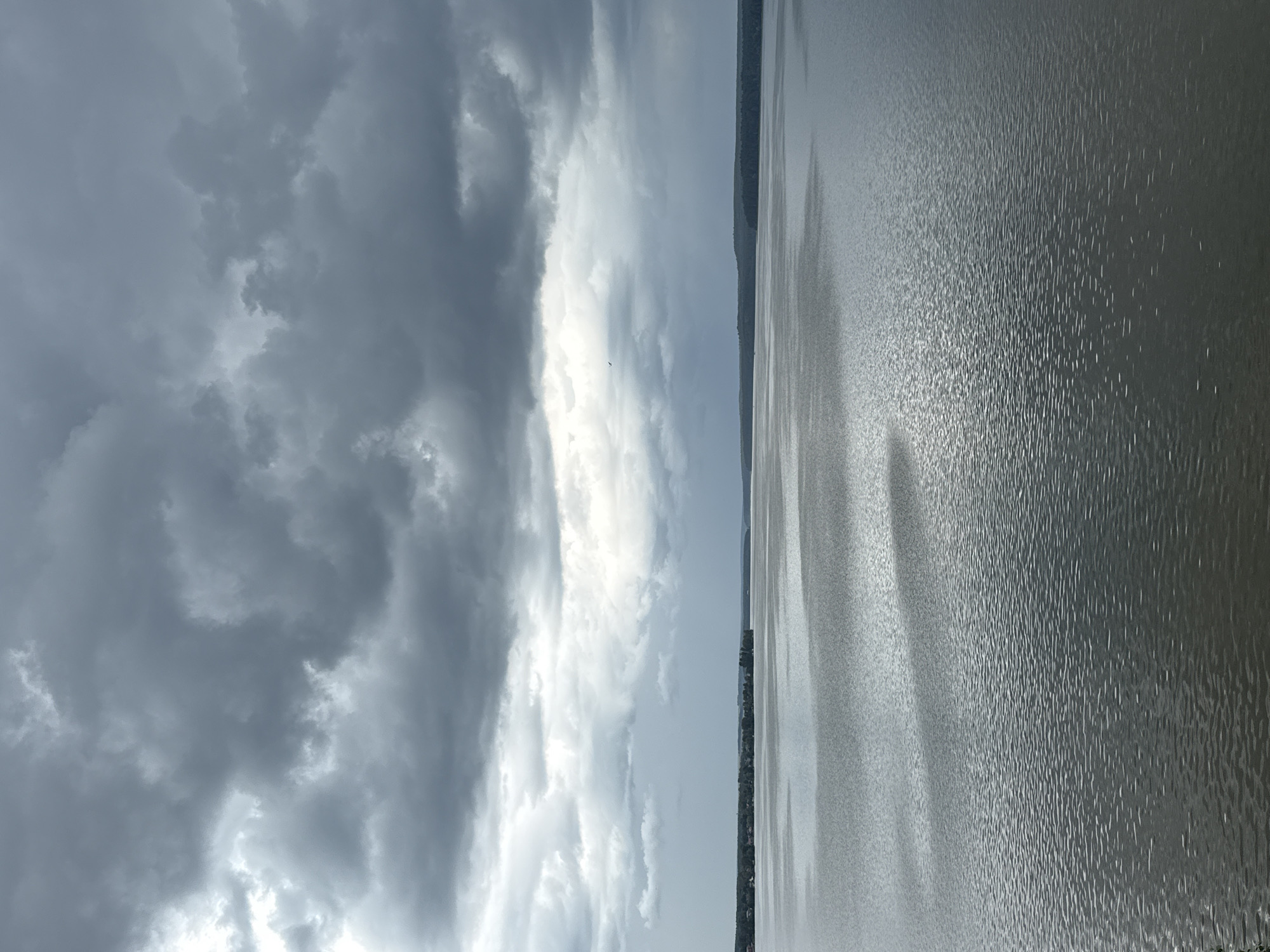 Storm clouds gather over a Votkinsk waterfront on a June morning