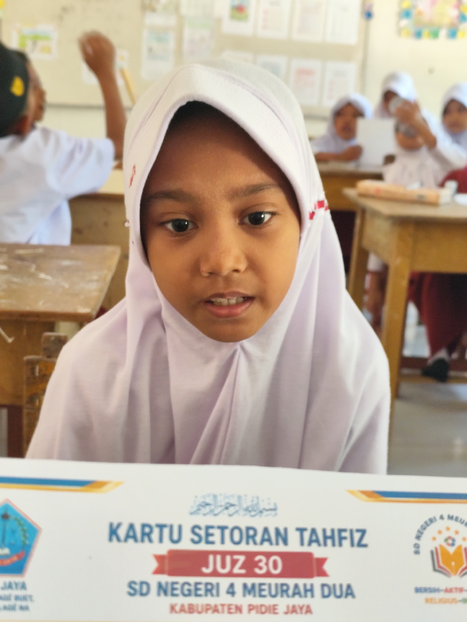 Students in a classroom, smiling and at work