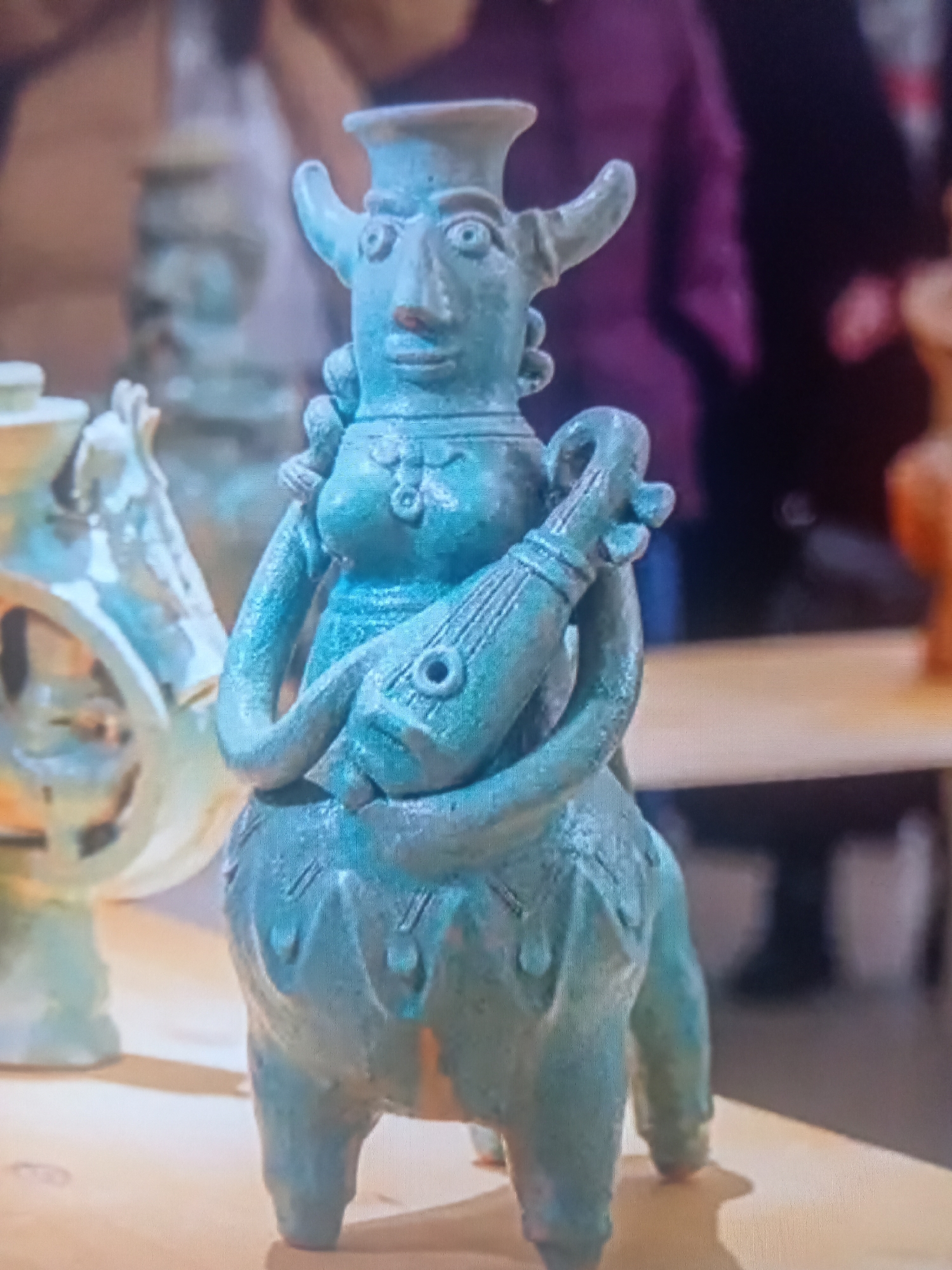 Art gallery visit mixing contemporary paintings and ancient ceramic artifacts