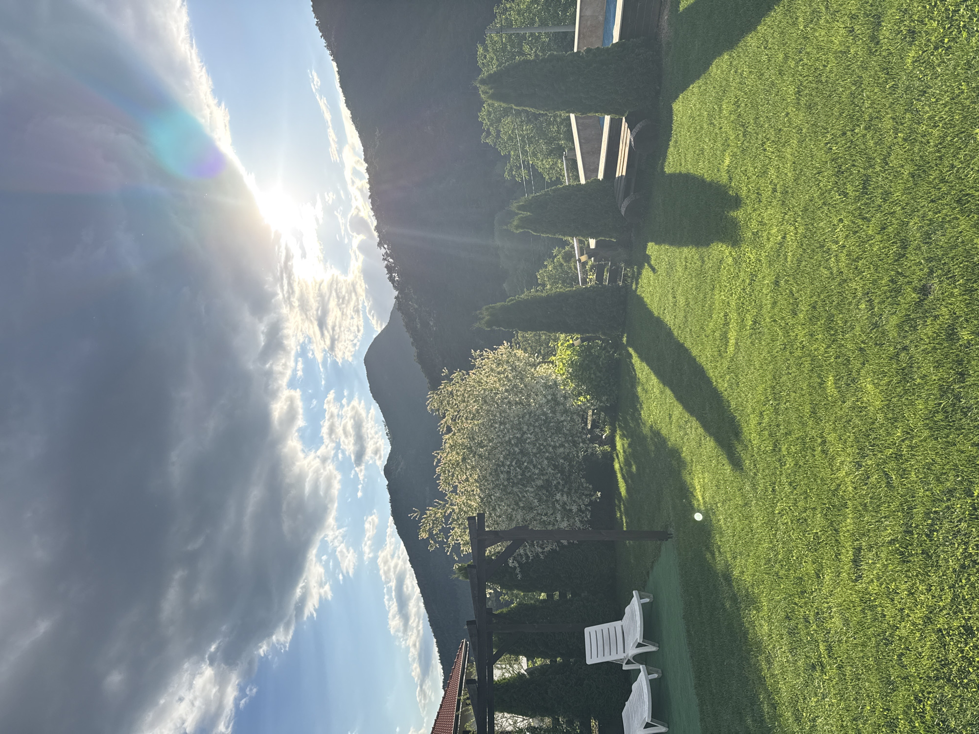Afternoon scenes documented in Bulgarian village with pool, mountains