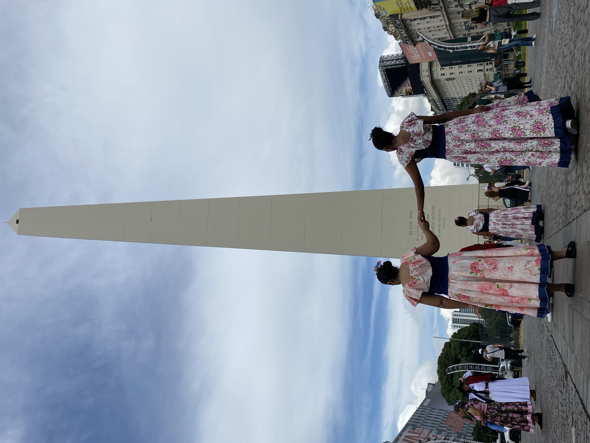 Women in traditional dress gather at Buenos Aires Obelisco