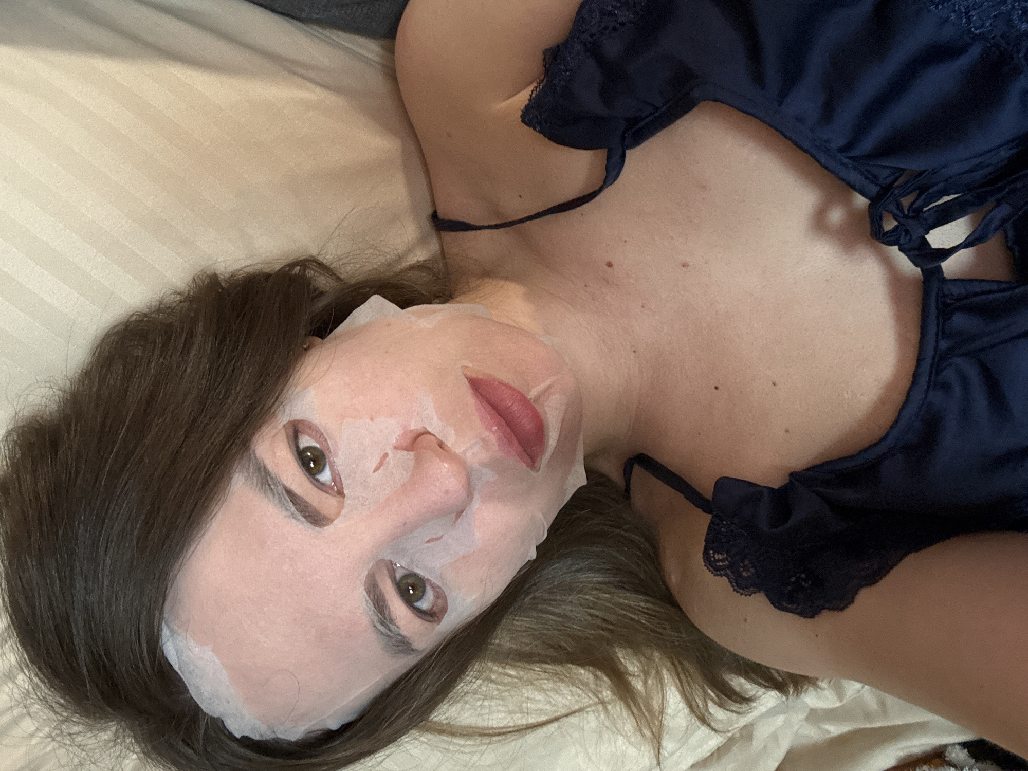Woman does evening skincare routine in Stary Oskol bedroom