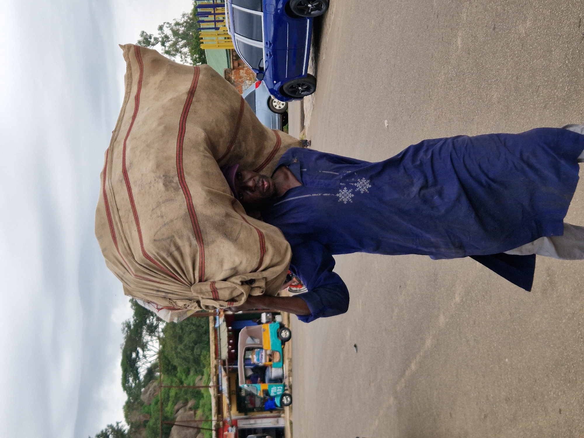 Street vendors and pedestrians moving through a busy urban market