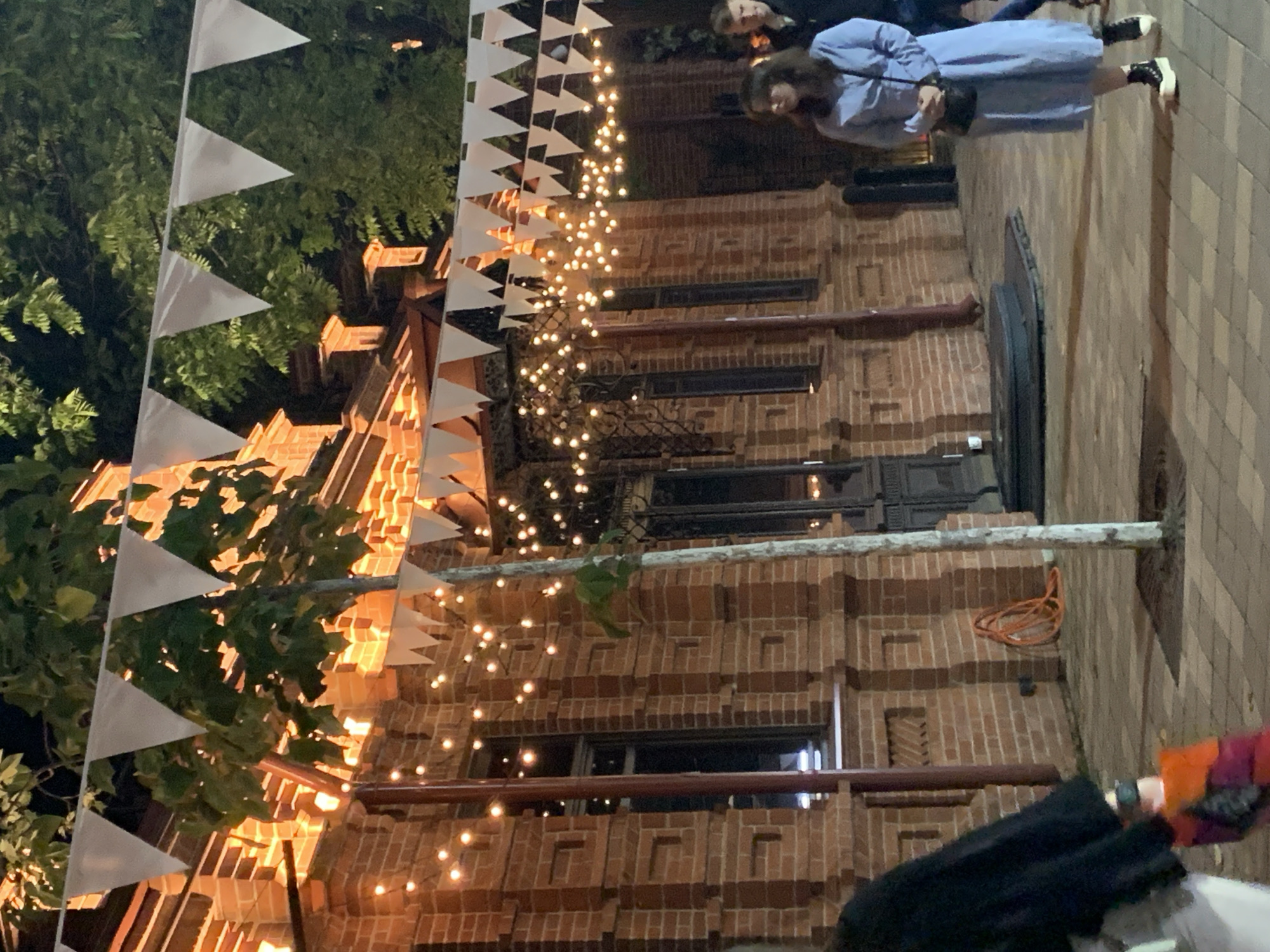Evening street festival features illuminated fountains and decorated walkways