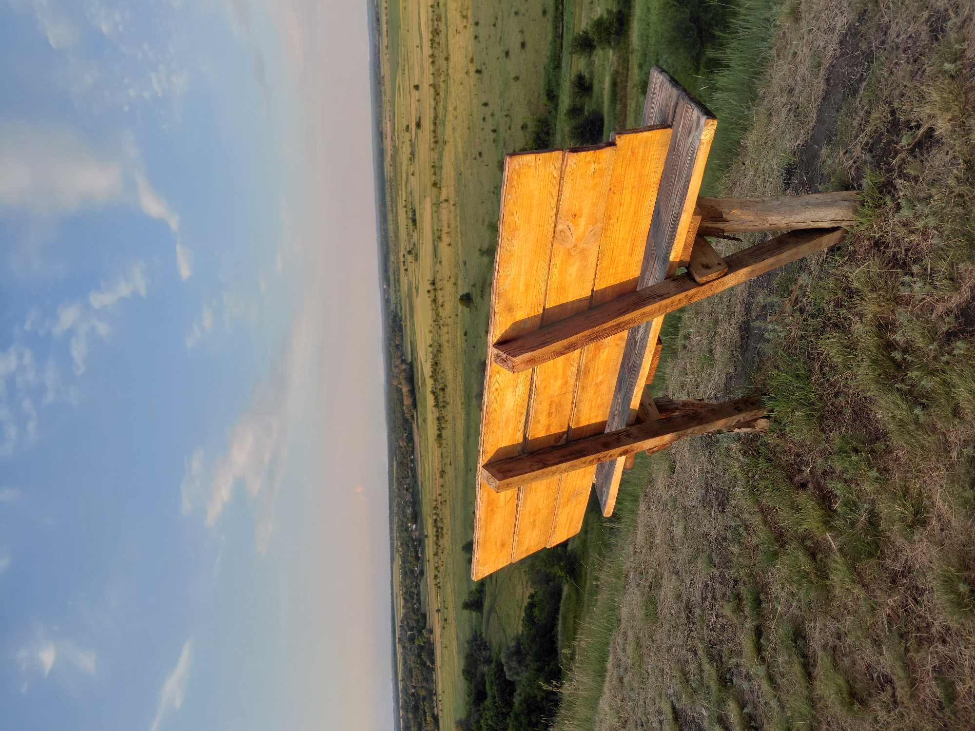 Golden hour across open fields and rolling rural hills