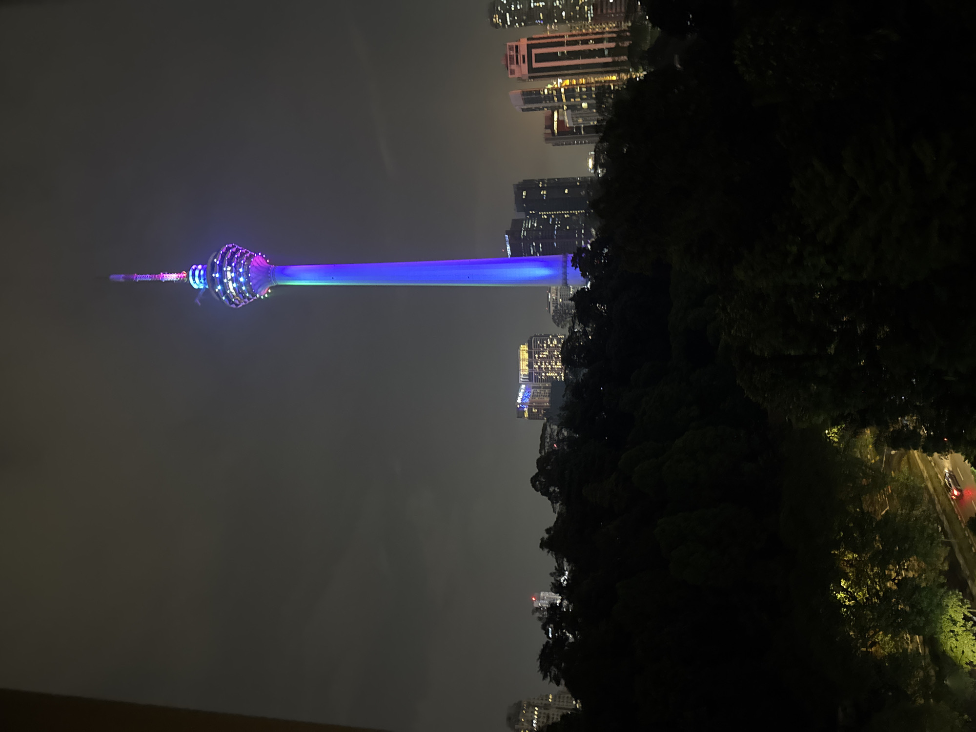 Nighttime gym workout session overlooks illuminated Kuala Lumpur skyline