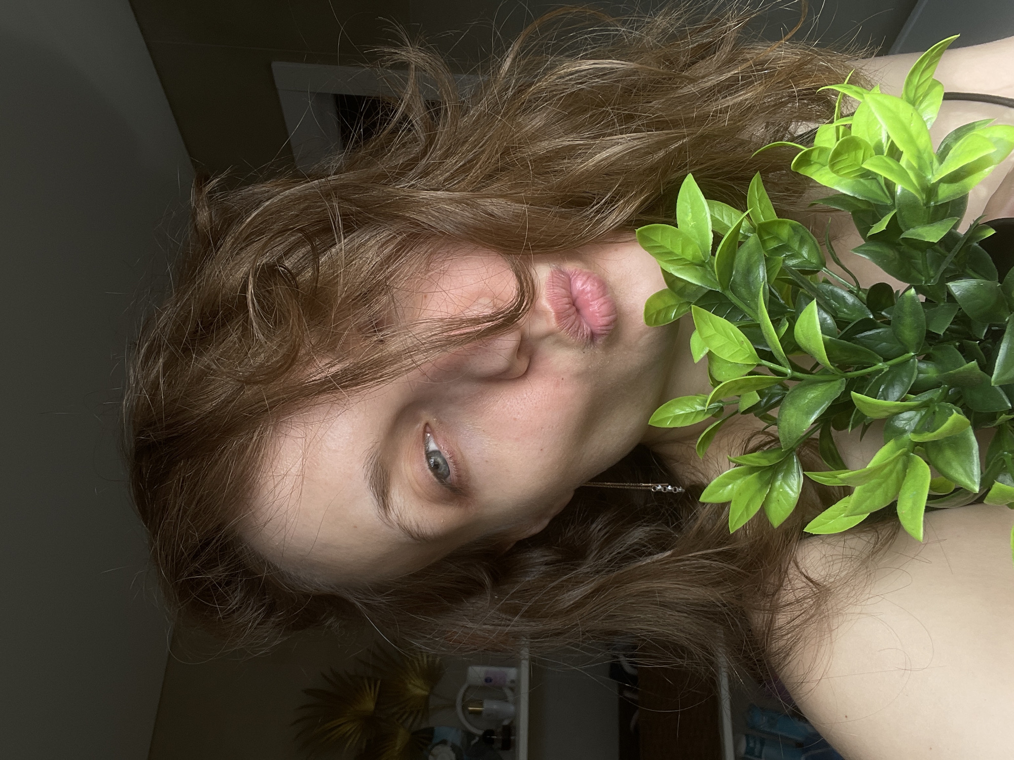 Woman poses with plants in Podshivalovo portrait session
