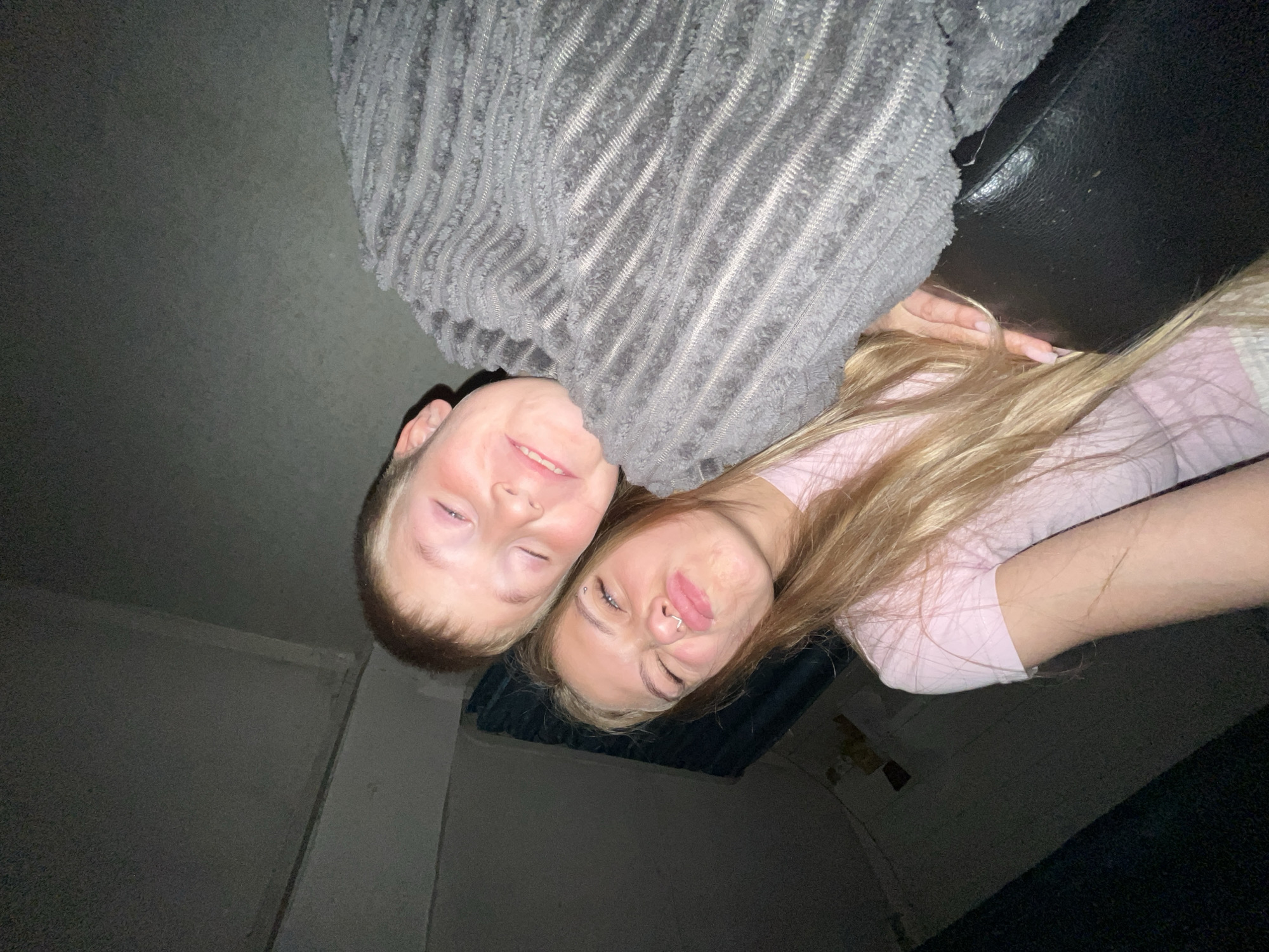 Young couple takes intimate selfie in dimly lit Russian room