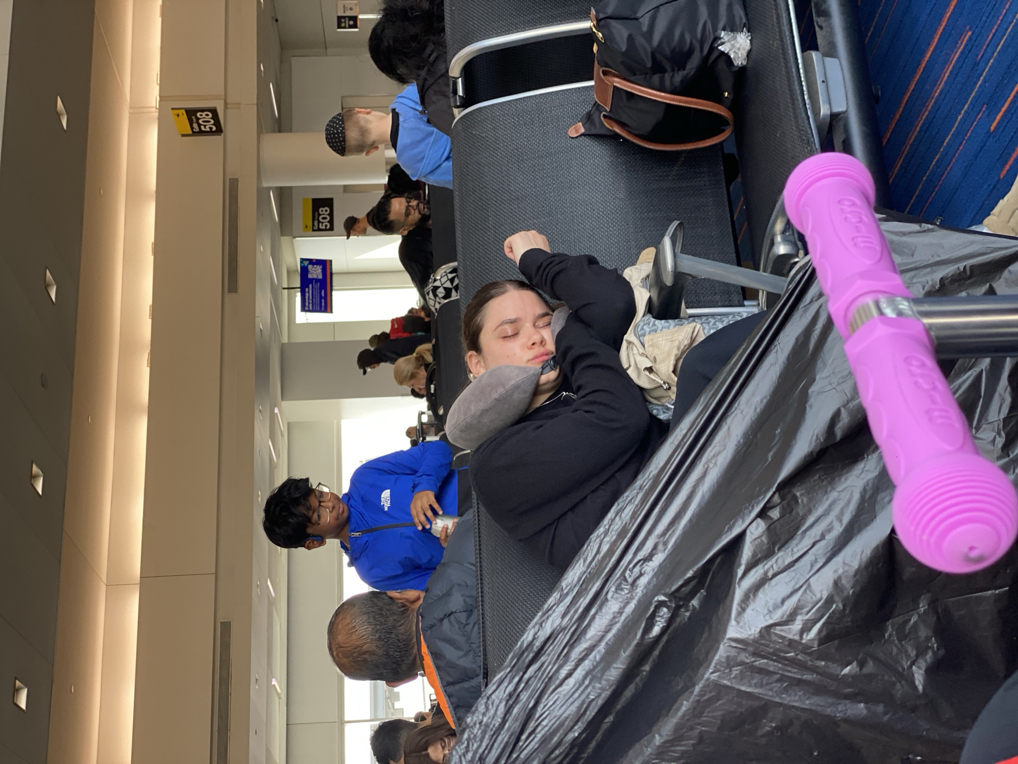 Passengers wait in NYC airport terminal during afternoon hours