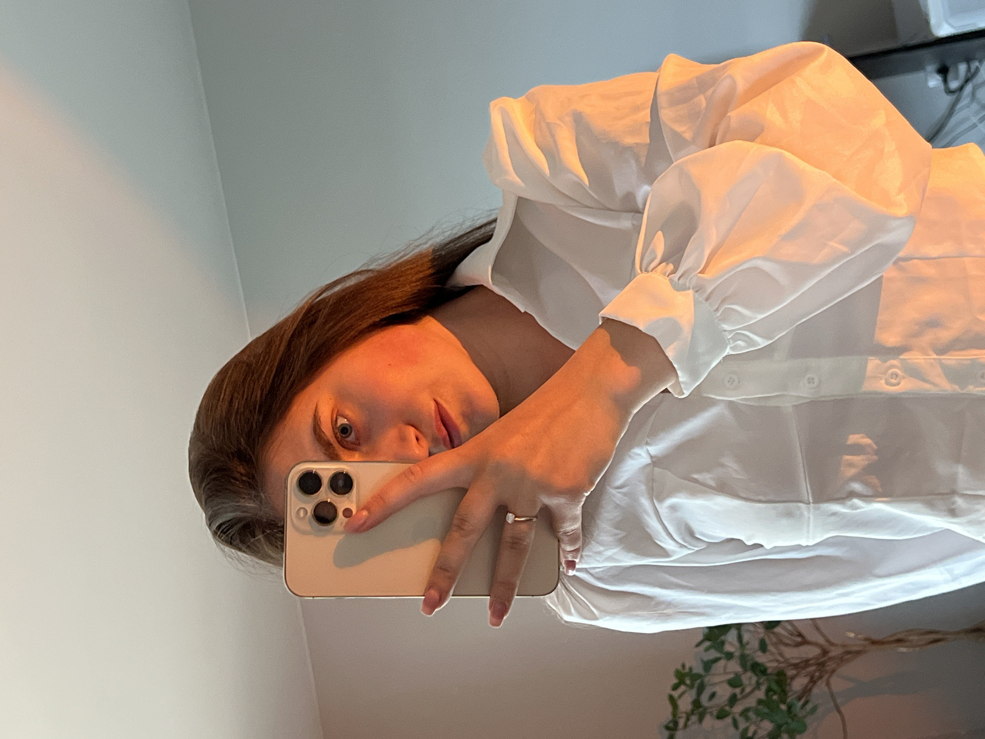 Woman takes multiple mirror selfies in white outfit in Ternopil