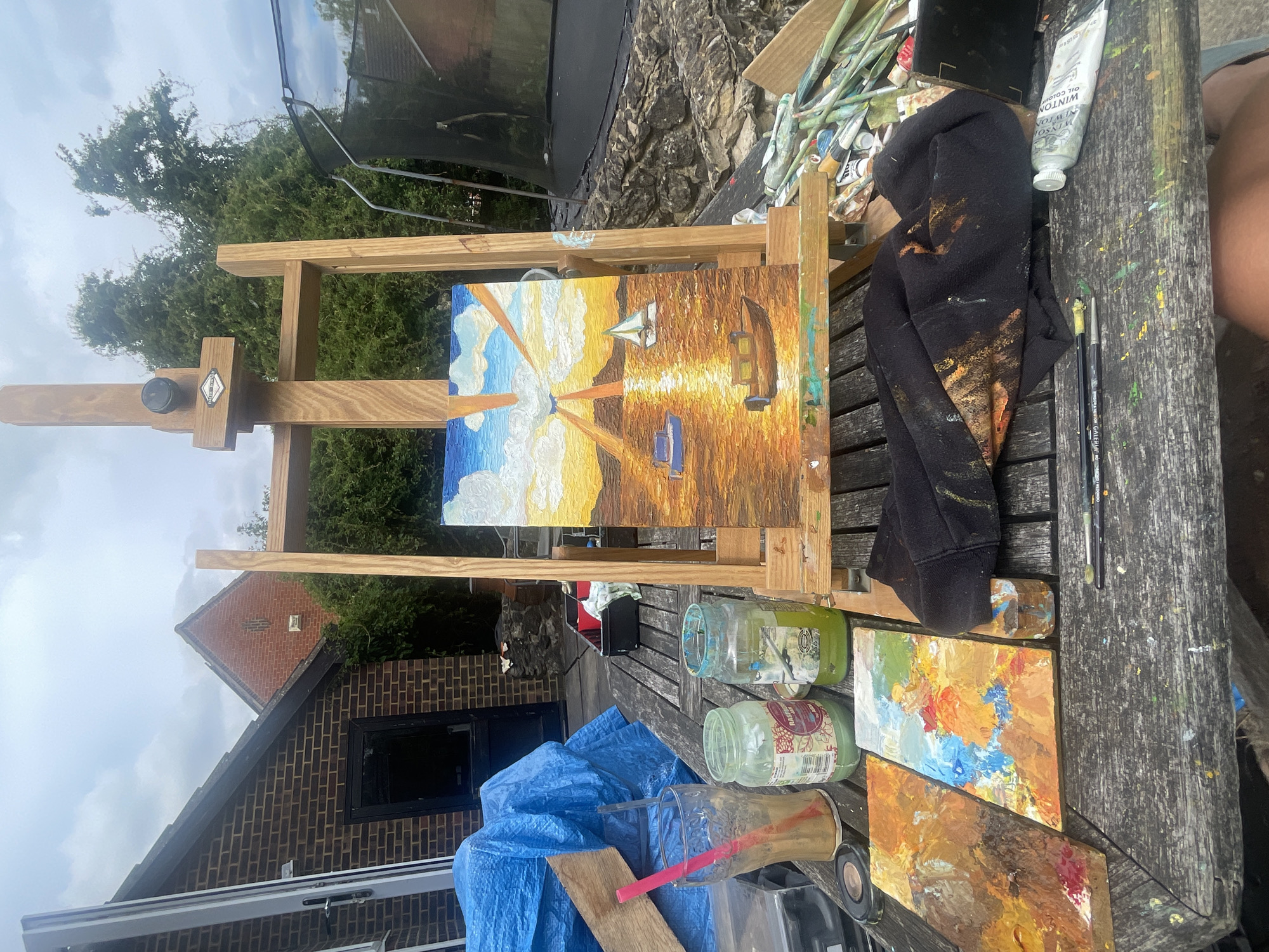 Artist paints seascape outdoors in Maidstone garden setting