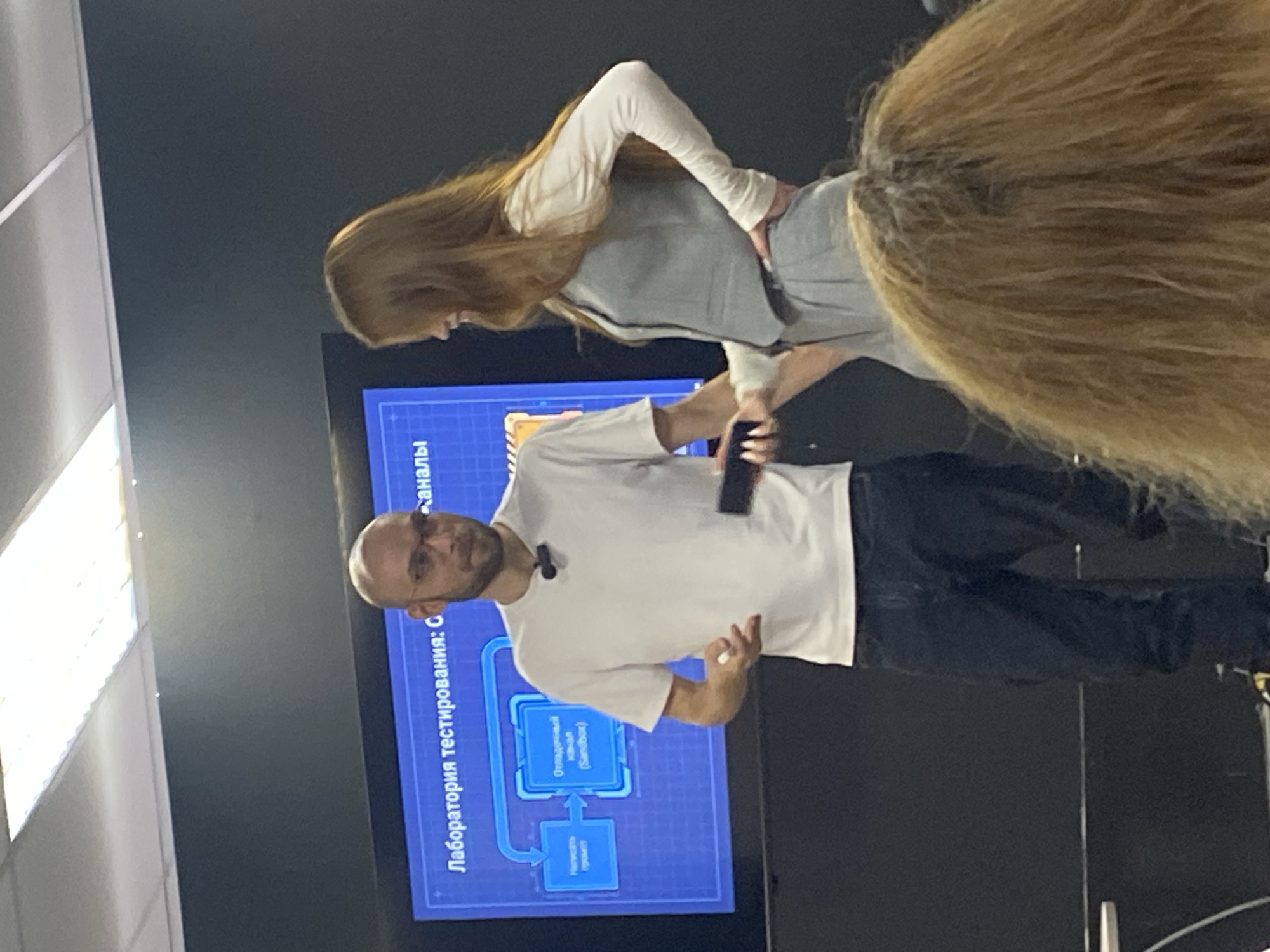 Indoor presentation with Russian-text diagram, Moscow