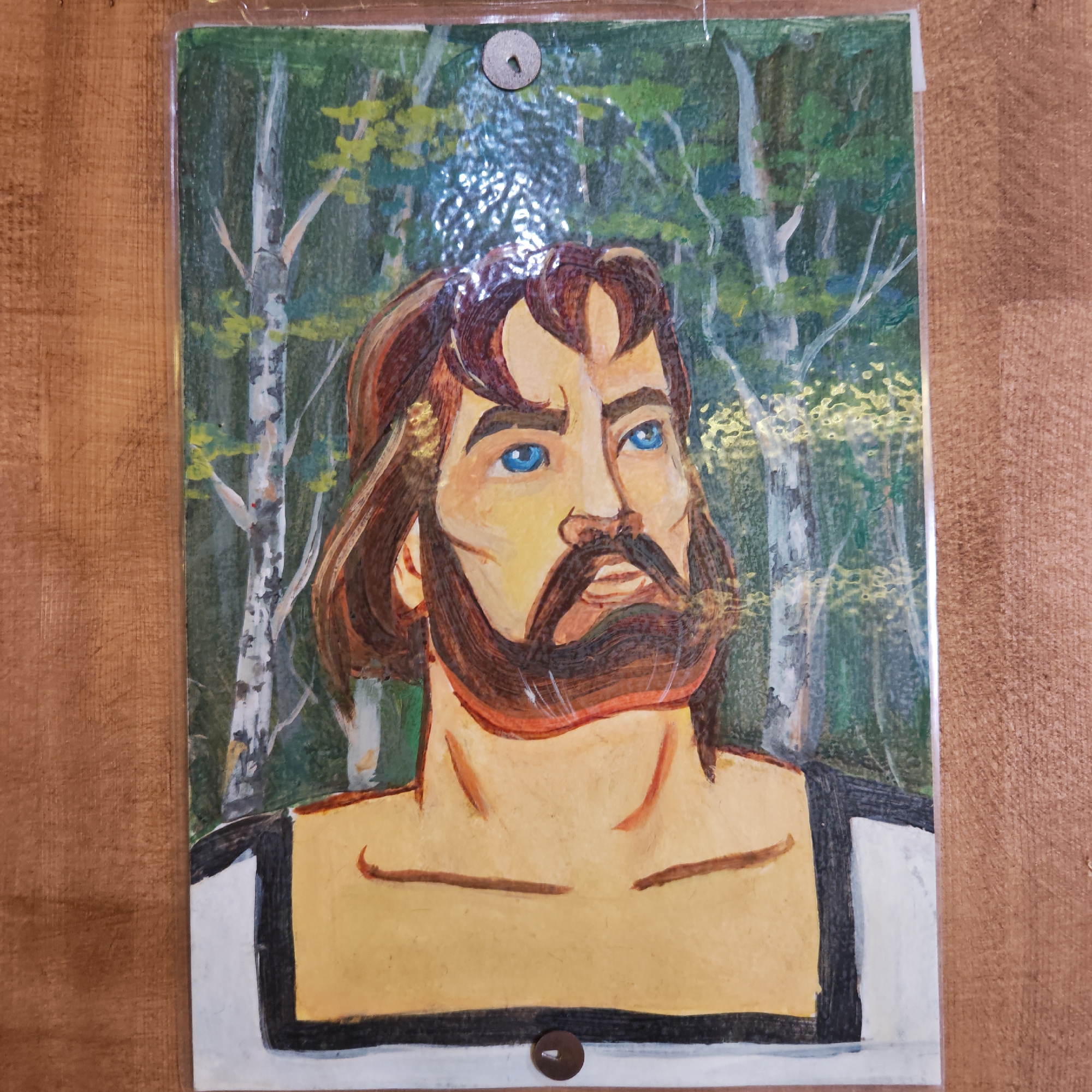 Portrait painting displayed on wooden wall in Russian town