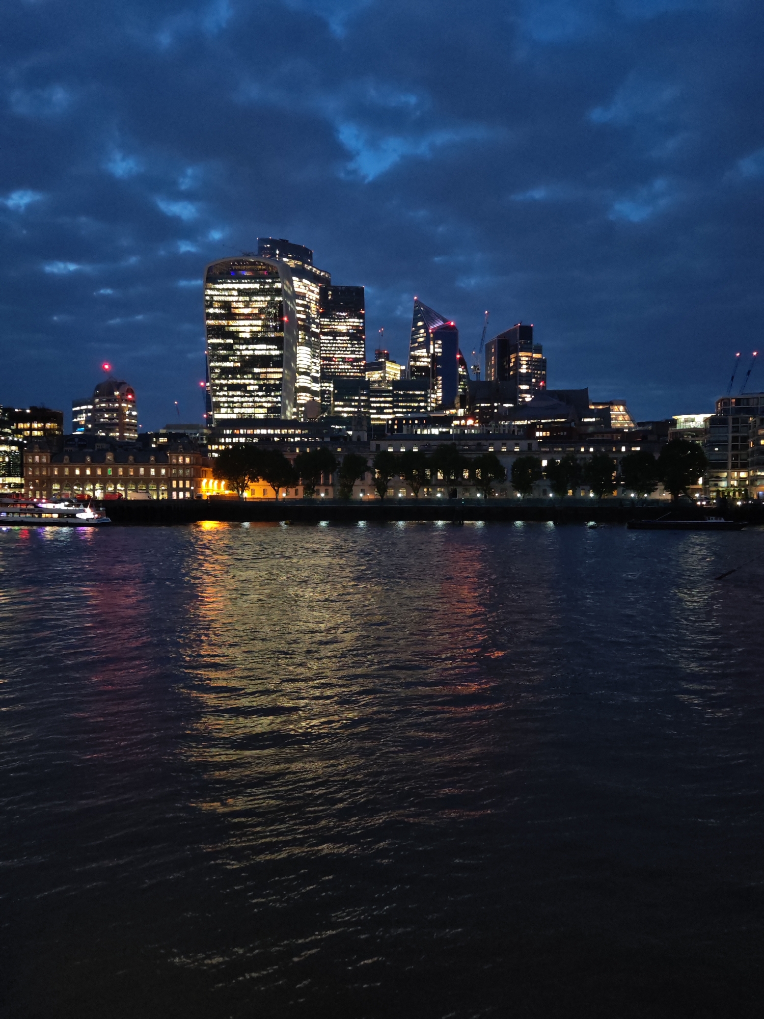 London landmarks illuminated at night from Thames viewpoint