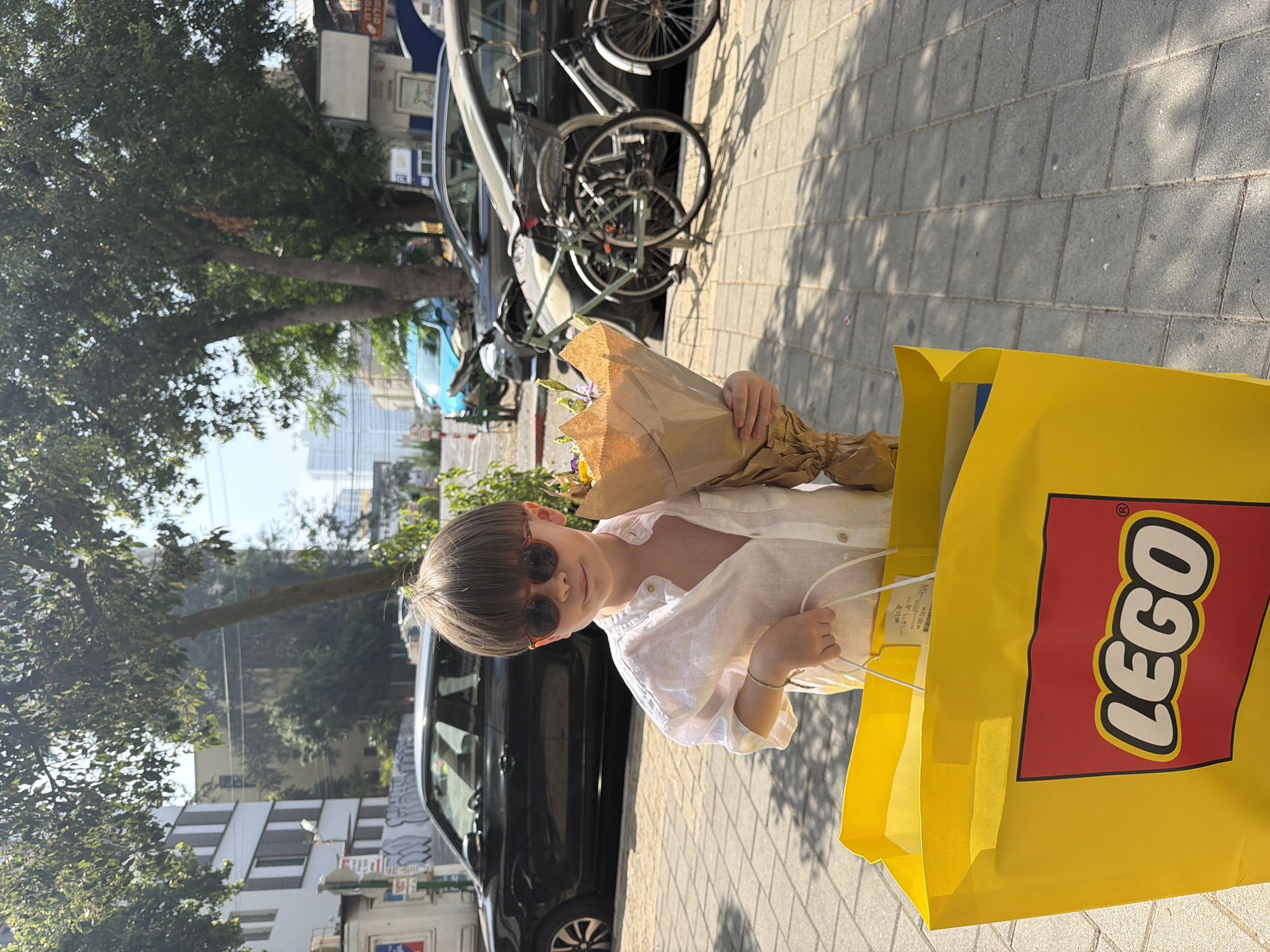 Boy with flowers spotted on Tel Aviv sidewalk Tuesday morning