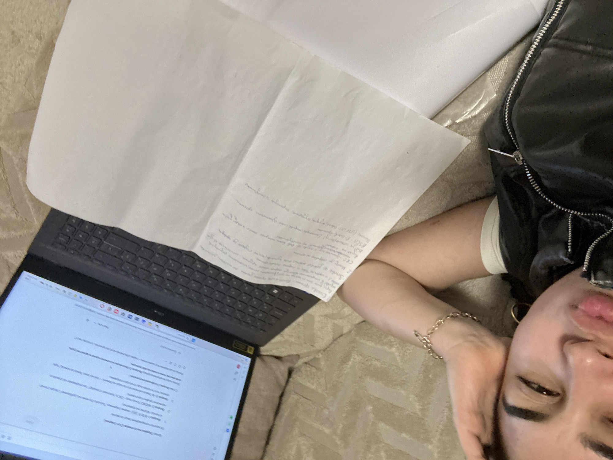 Person rests with laptop and papers in Burgas