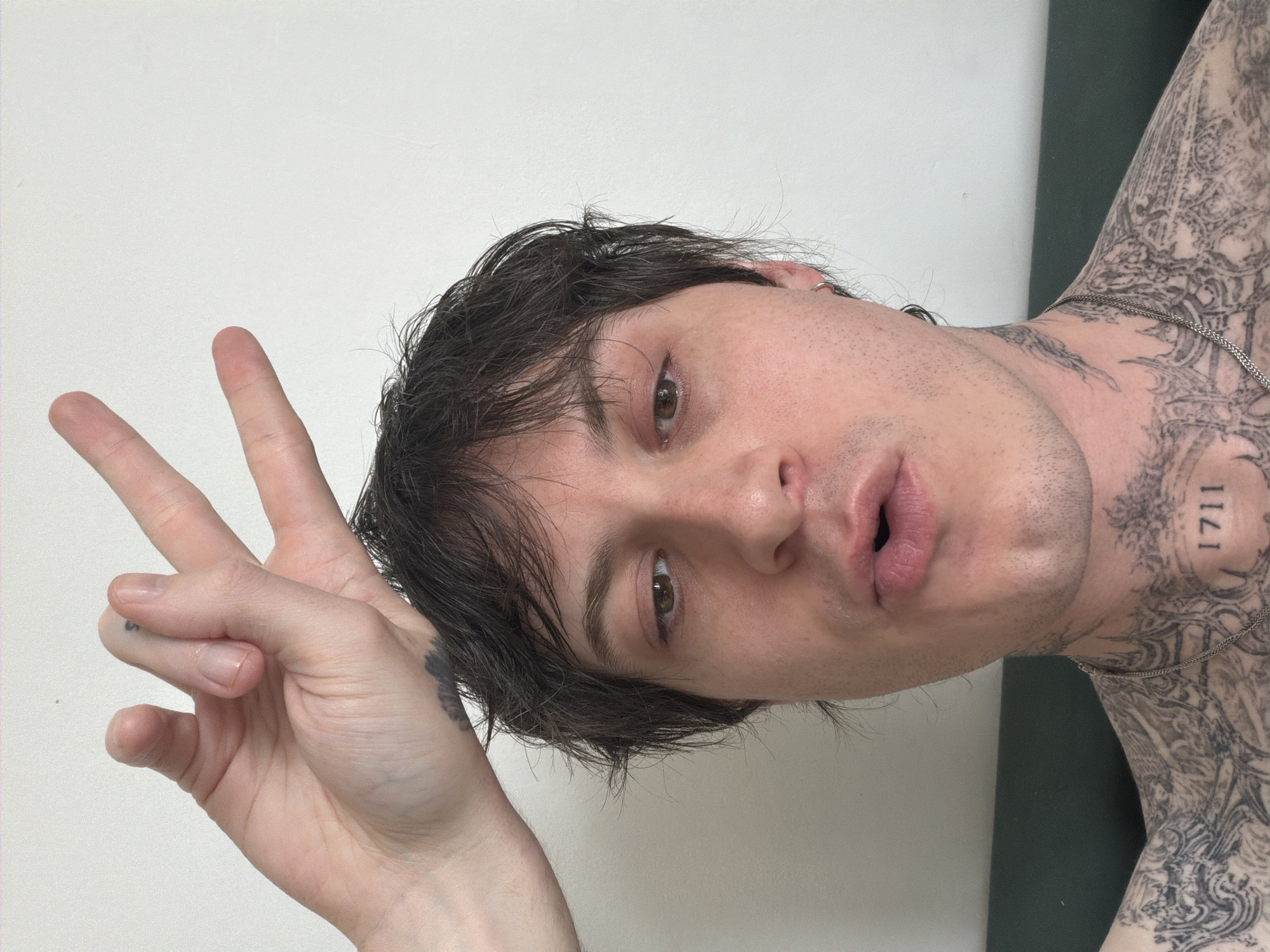 Person makes peace sign gesture captured in London