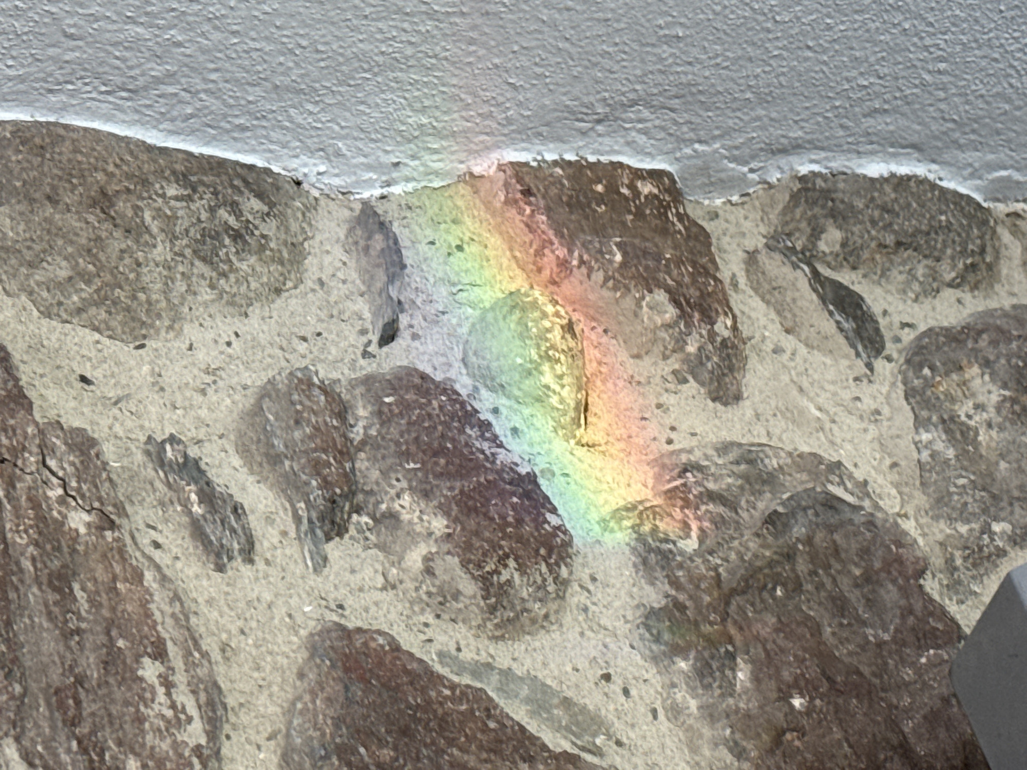 Rainbow reflections and snowy mountains observed in Benasque