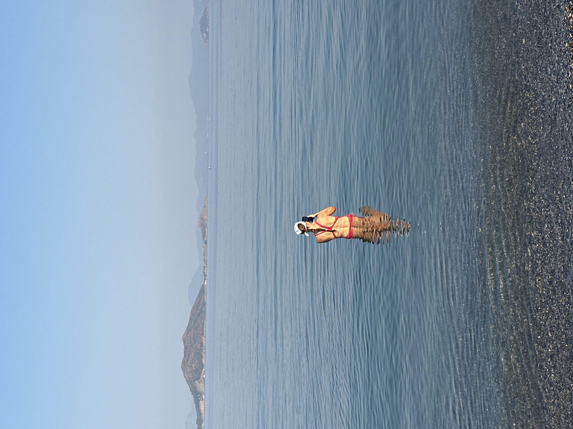 Calm morning at a Fethiye pebble beach and bay