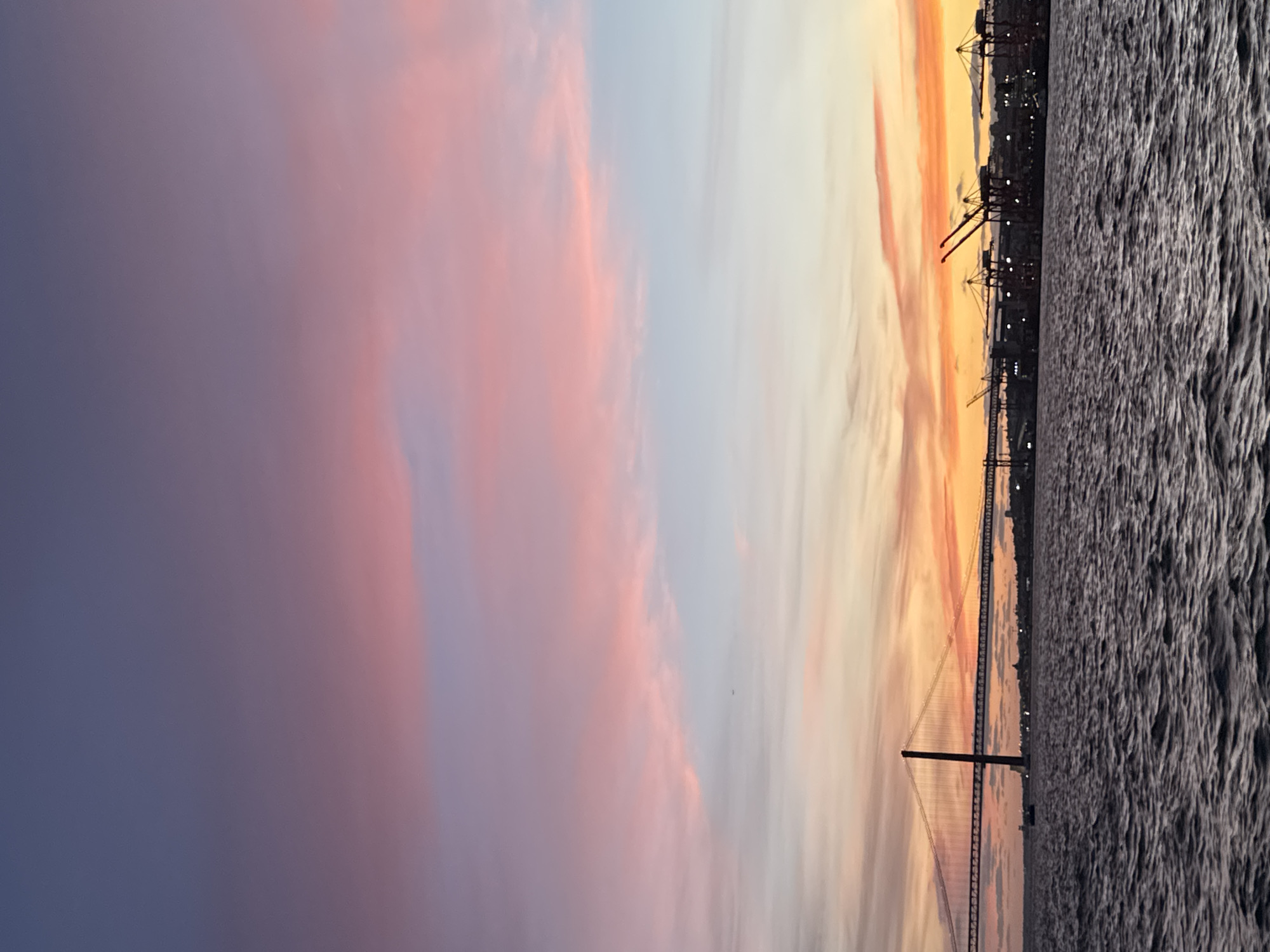 Sunset colors illuminate 25 de Abril Bridge in Portugal