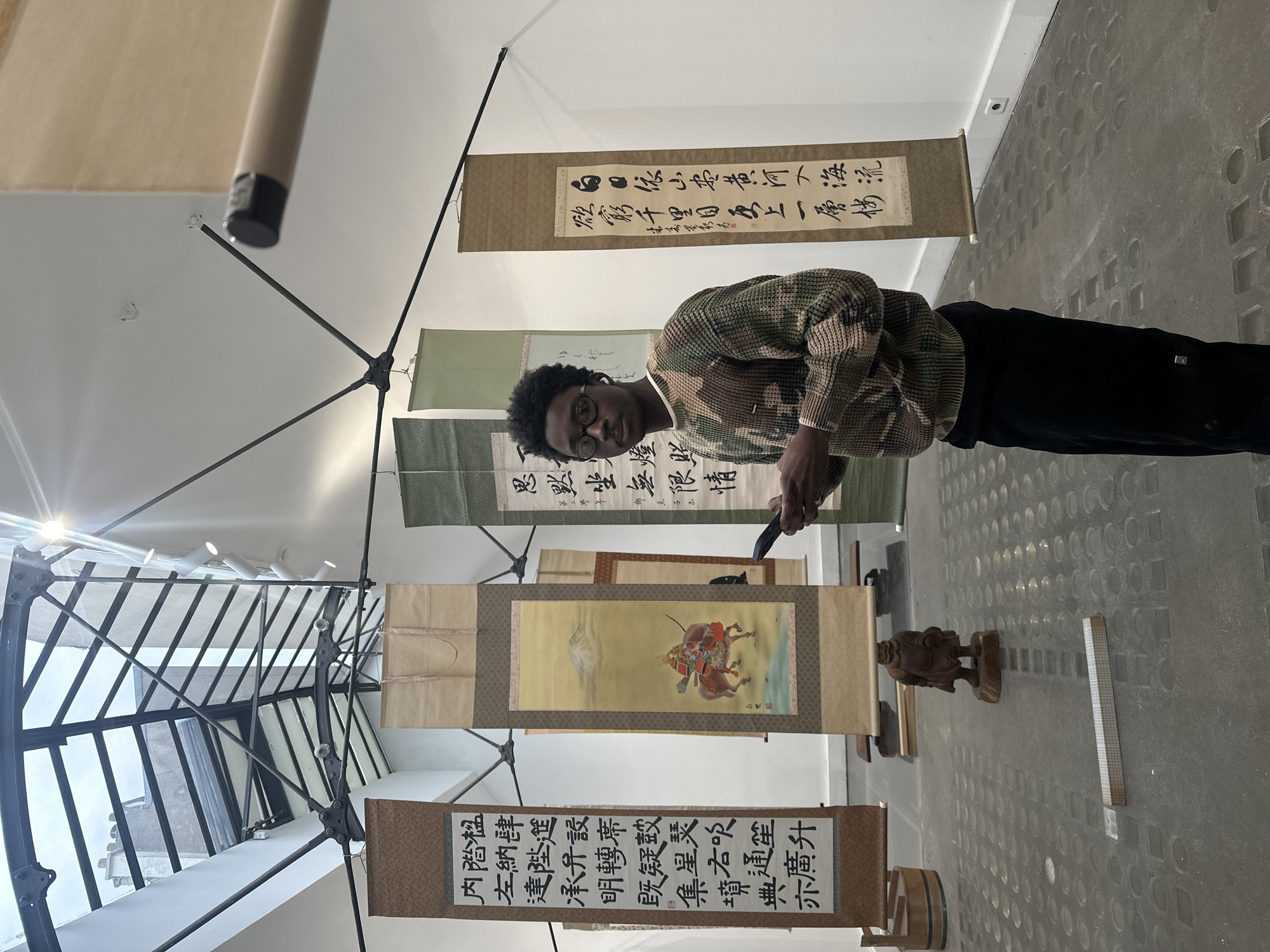 Visitors explore Asian art exhibition in Paris gallery