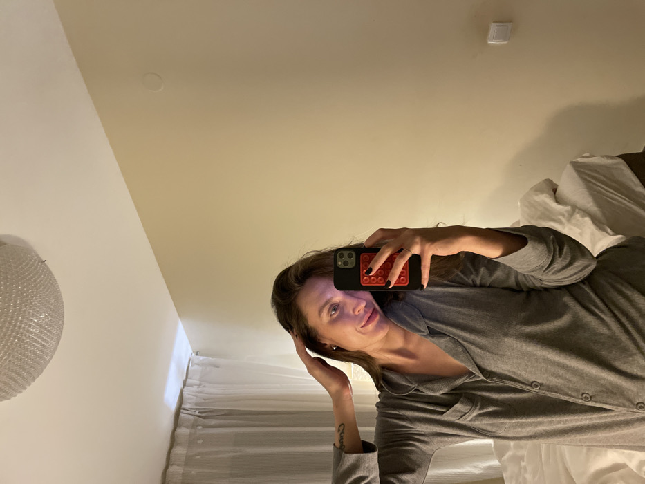 Evening skincare and pet bonding session in Budva bedroom