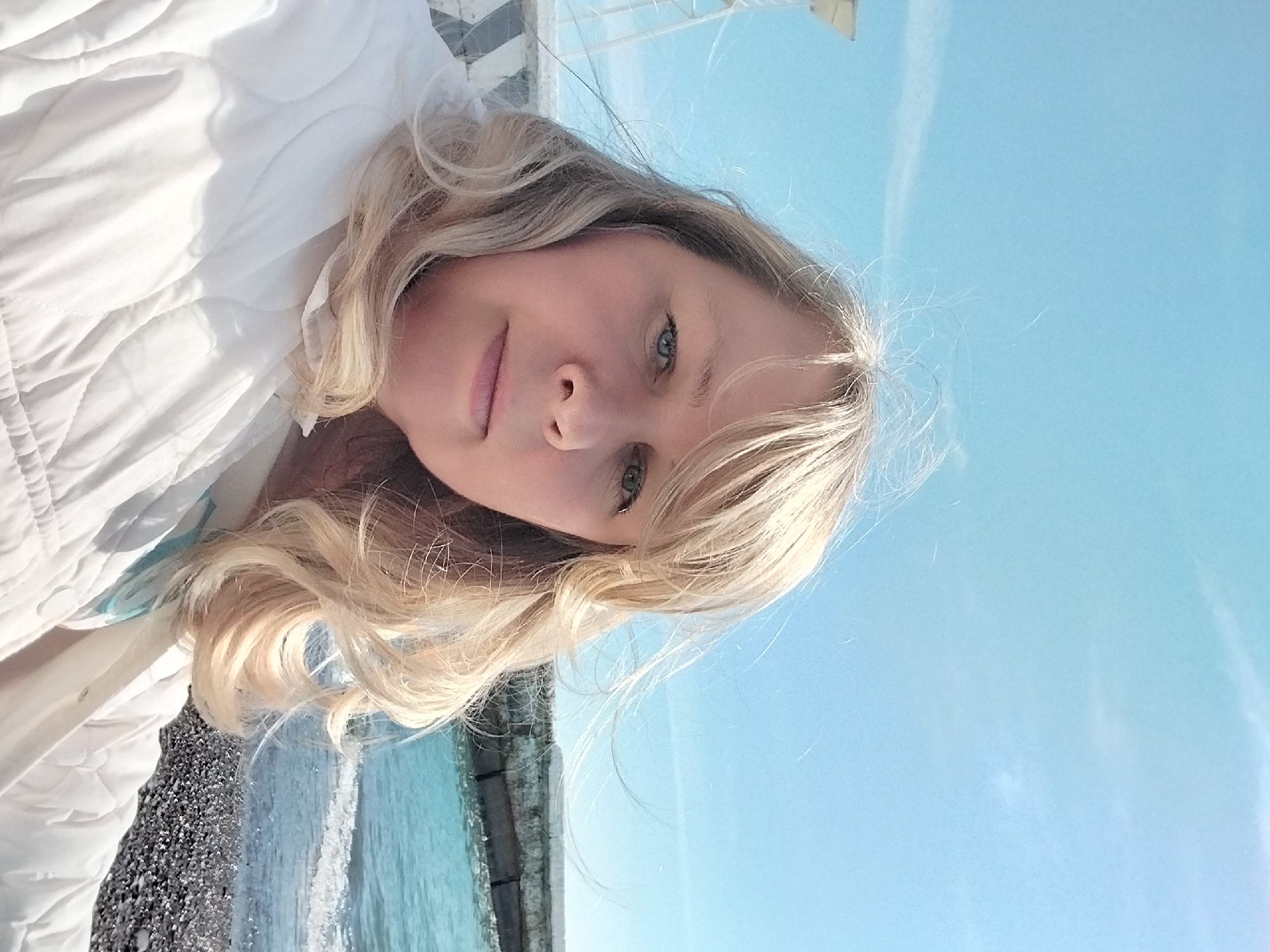 Blonde woman photographed at Sochi coastal locations during sunny morning