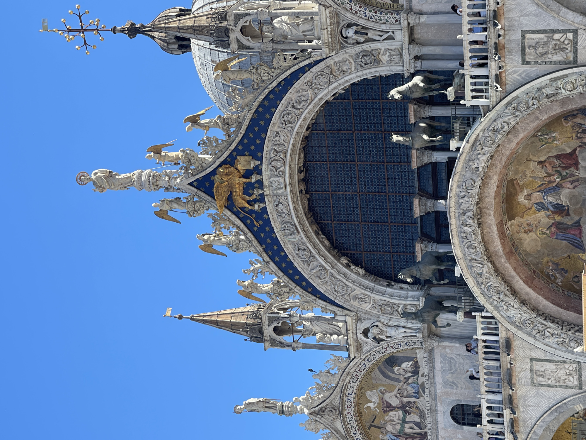 Tourist photographs St. Mark's Square landmarks on sunny morning