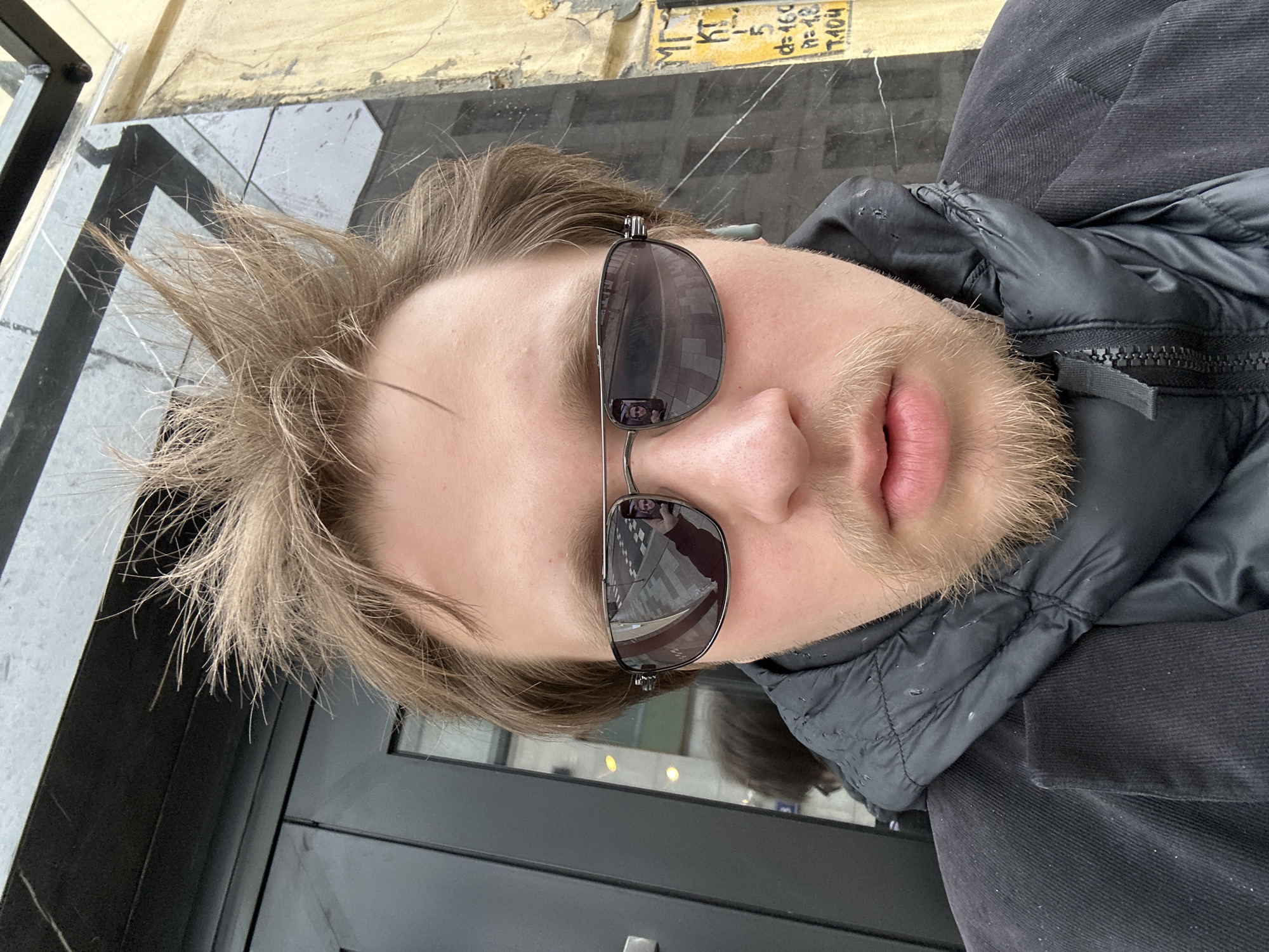 Person takes selfies near coffee shop Tuesday morning