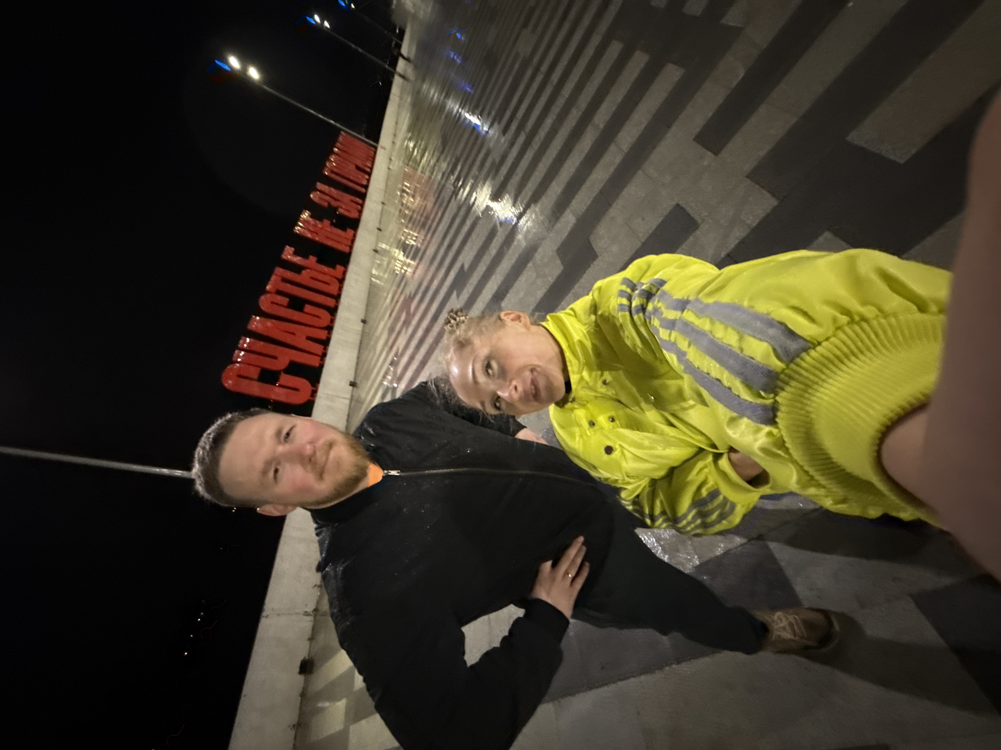 Nighttime photo session captures yellow-jacketed visitor touring central Perm landmarks