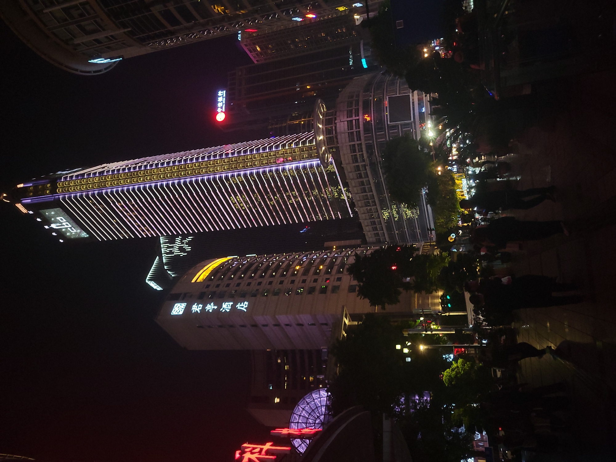 Evening street life documented in Chongqing's illuminated Yuzhong District