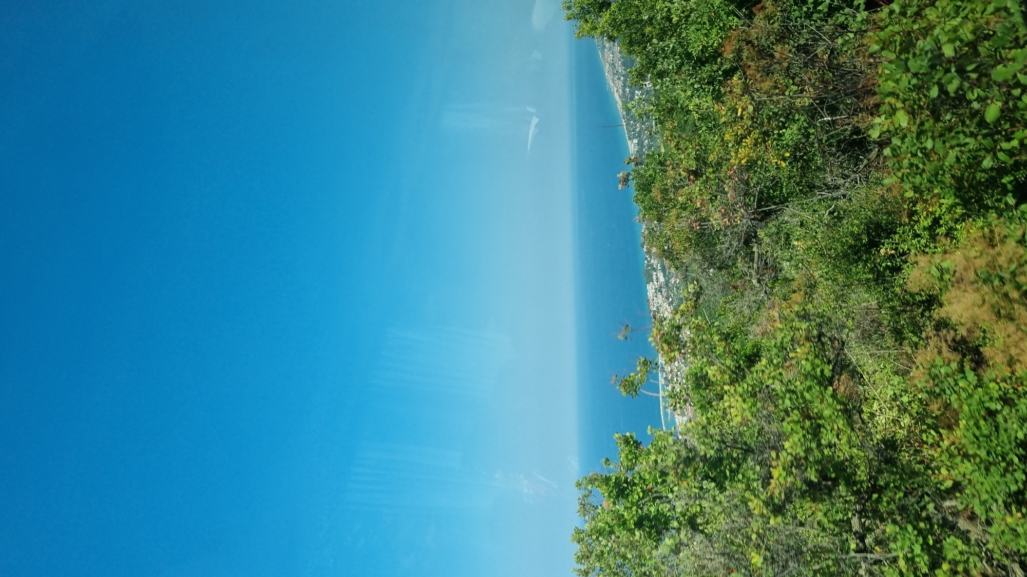 Hillside views over a Greek coastal town on a clear summer day