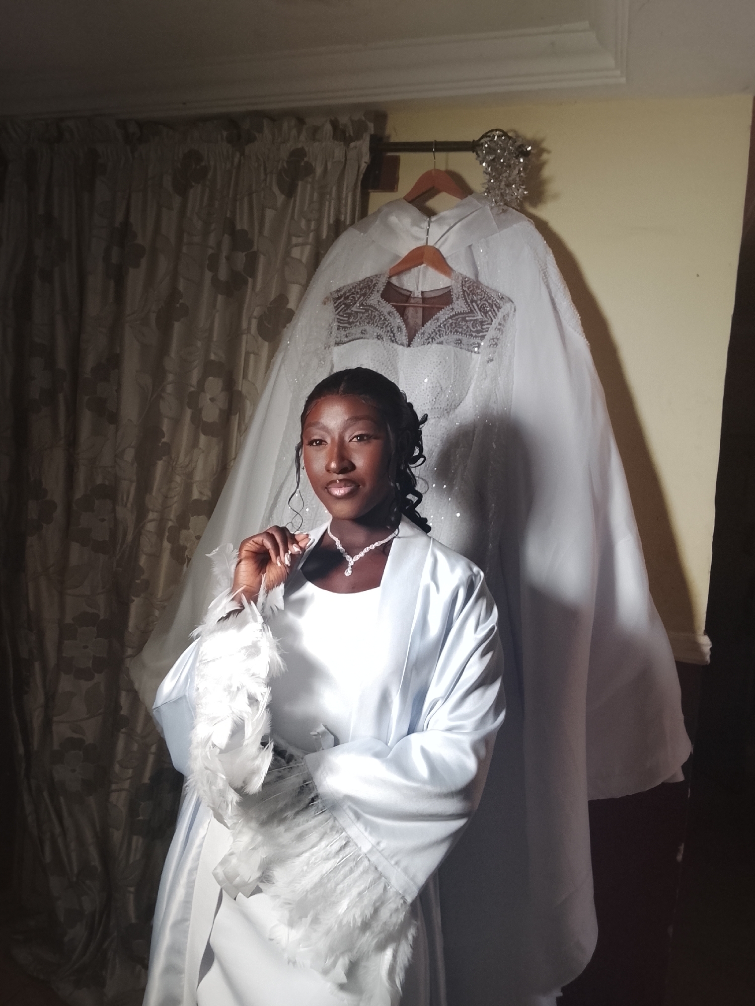 Women in white robes gather for wedding preparations