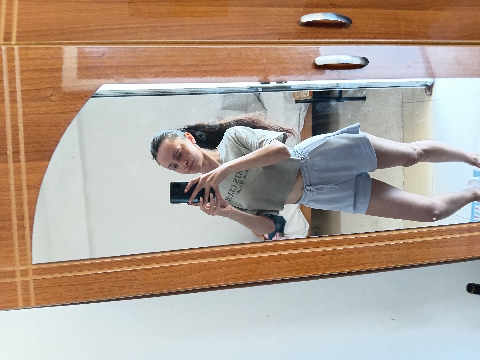 Woman takes mirror selfies in Vlora, Albania apartment