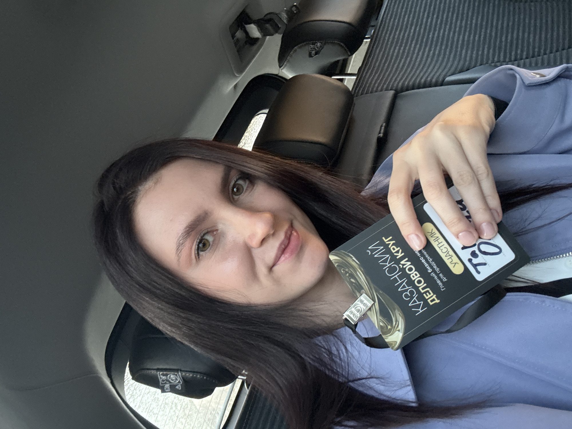 Woman takes selfie in car backseat in Kazan