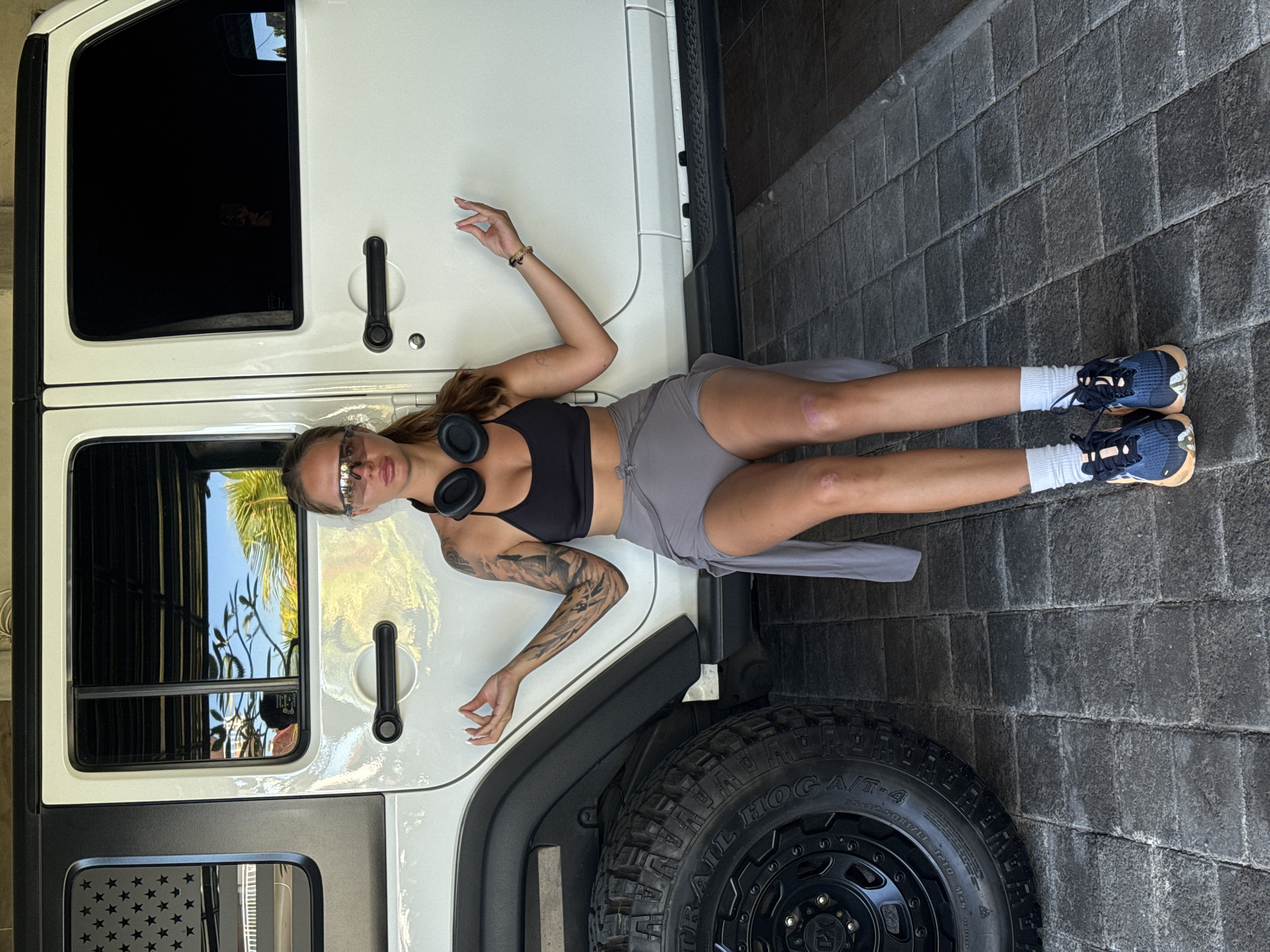 Woman poses with Jeep Wrangler in North Kuta garage