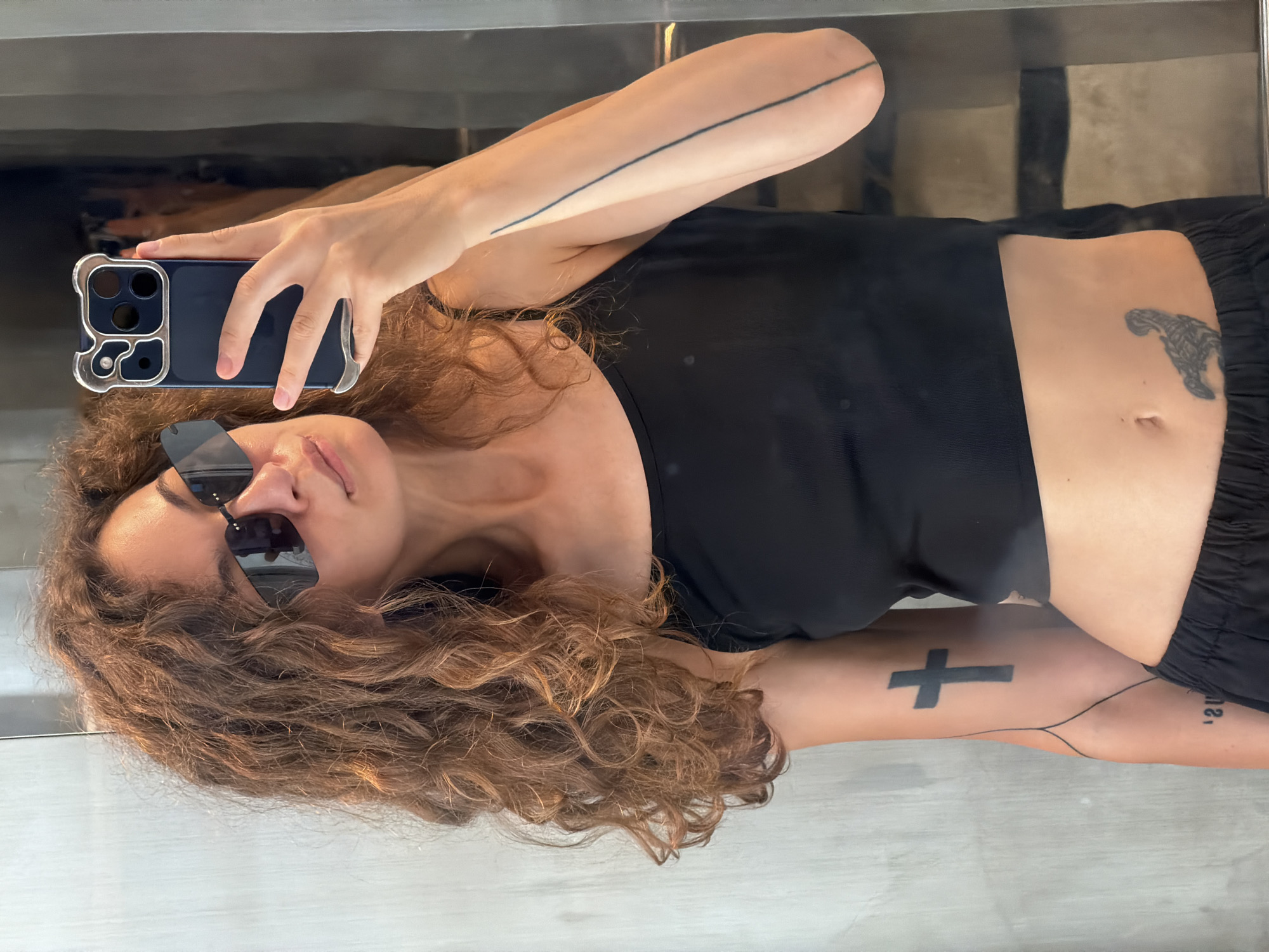 Woman takes selfie in front of reflective surface in Đà Nẵng