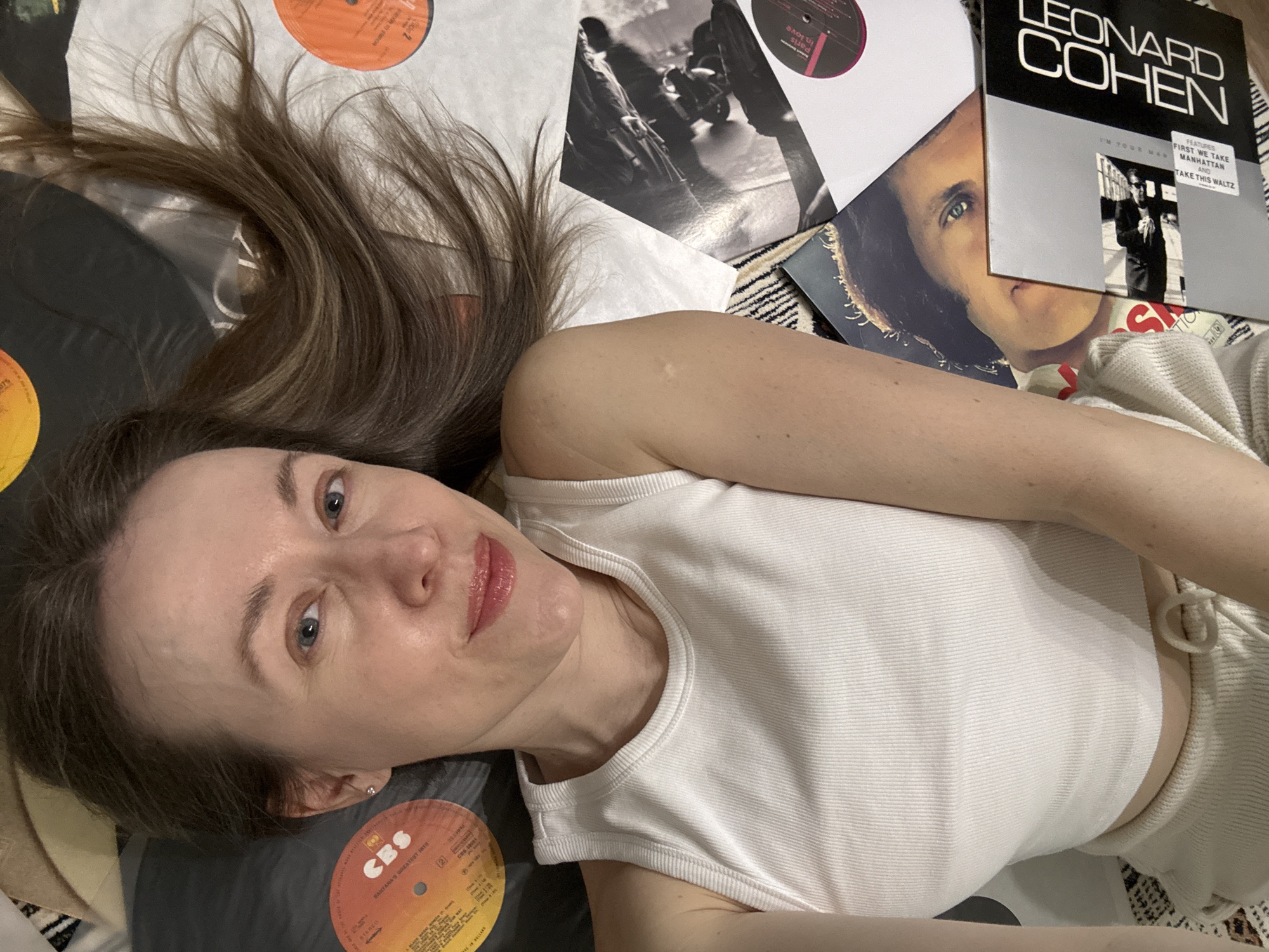 Woman poses with vinyl records in Kudrovo music photo session