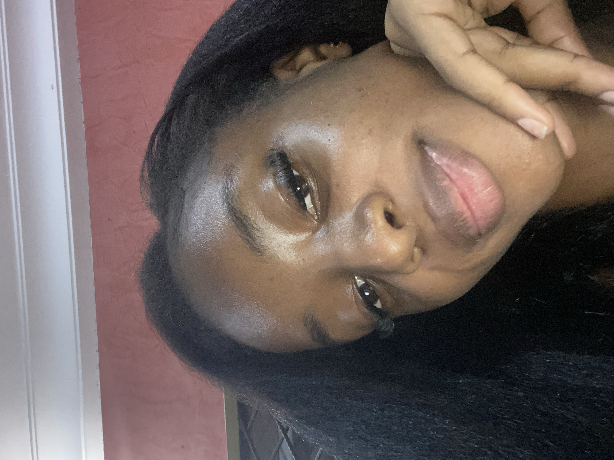 Woman takes selfie portraits indoors in Jos, Nigeria
