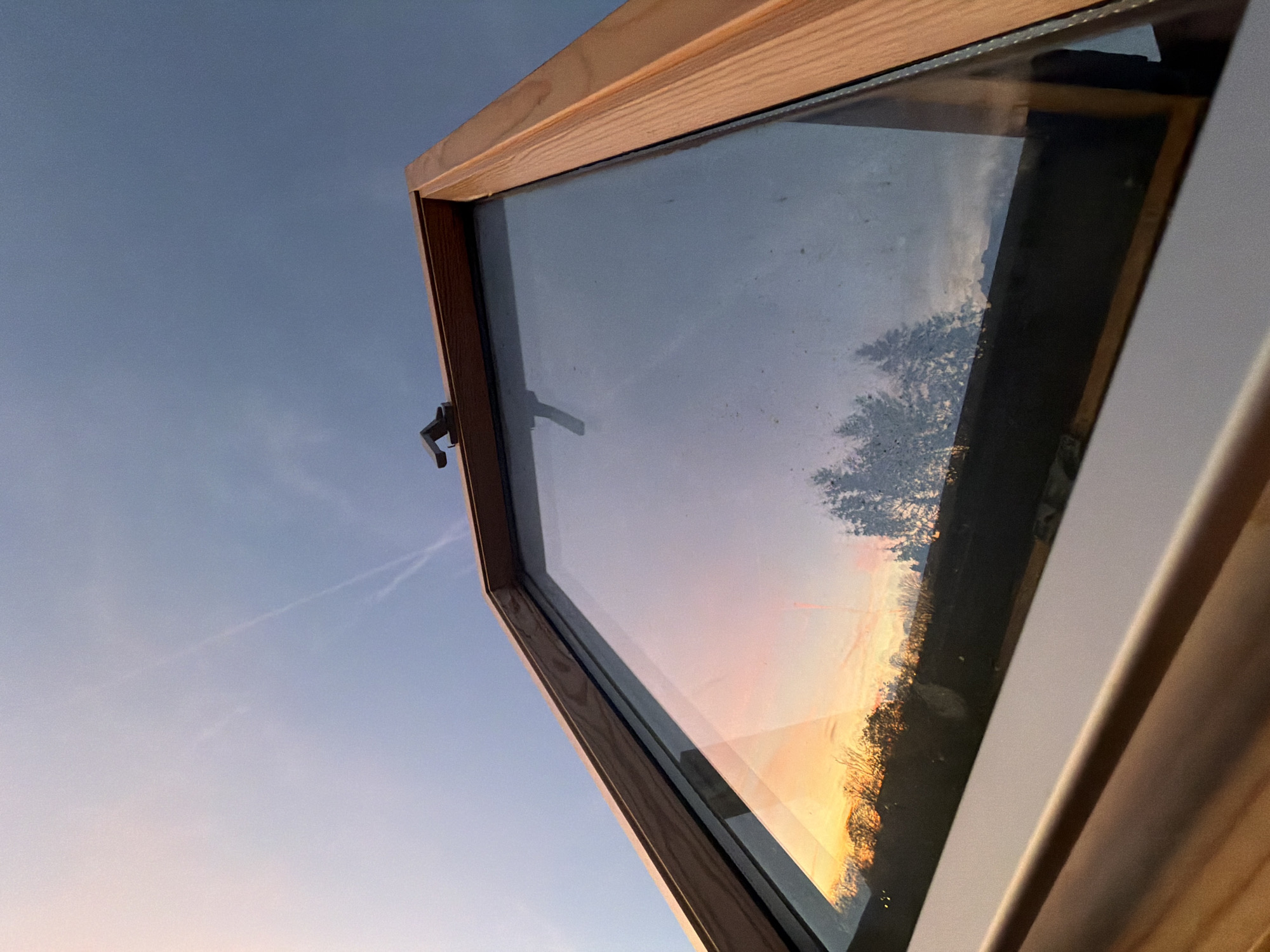 Aircraft contrails create sky patterns over Luxembourg