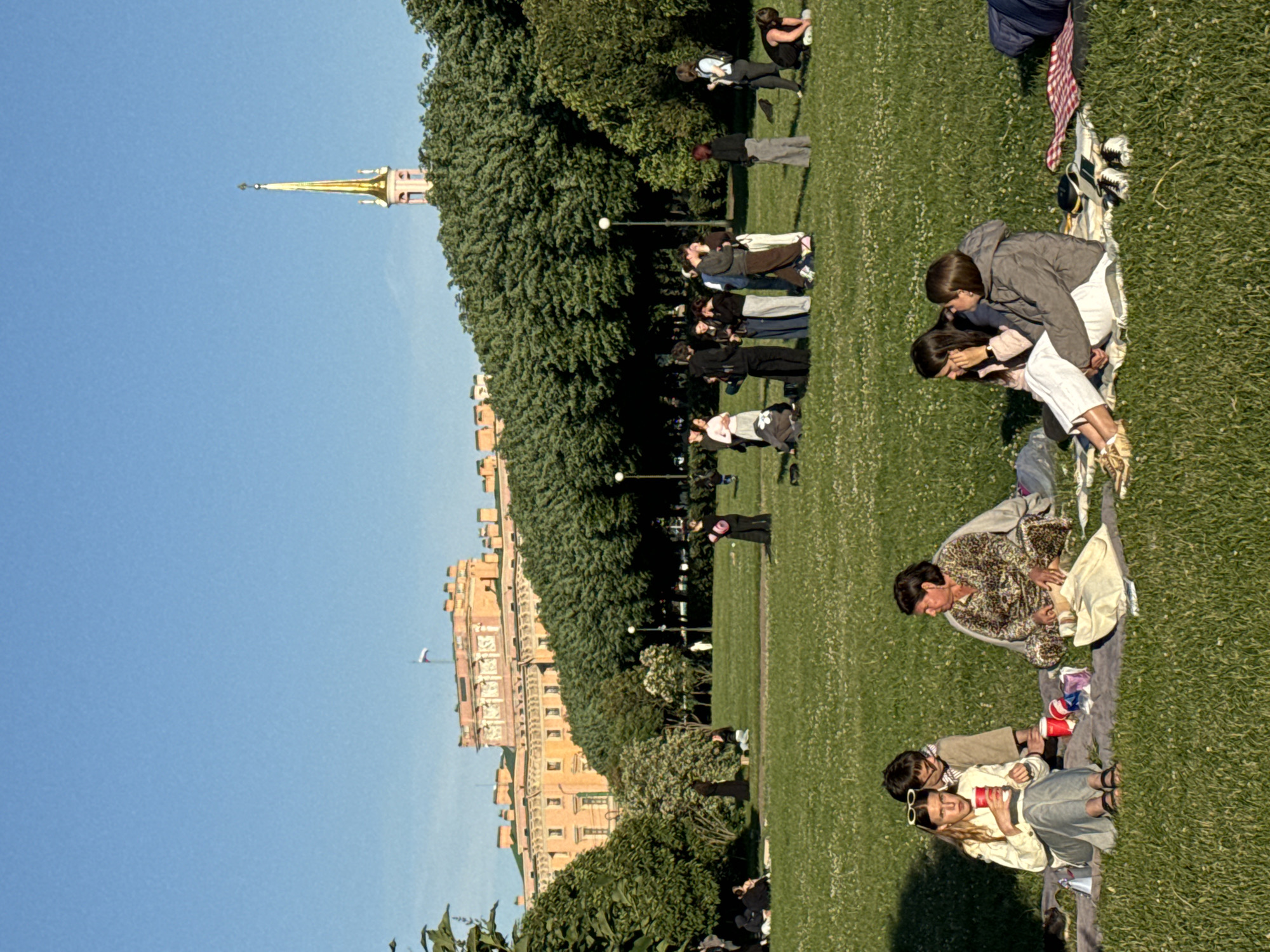 Evening crowds gather across Saint Petersburg's historic landmarks during sunset