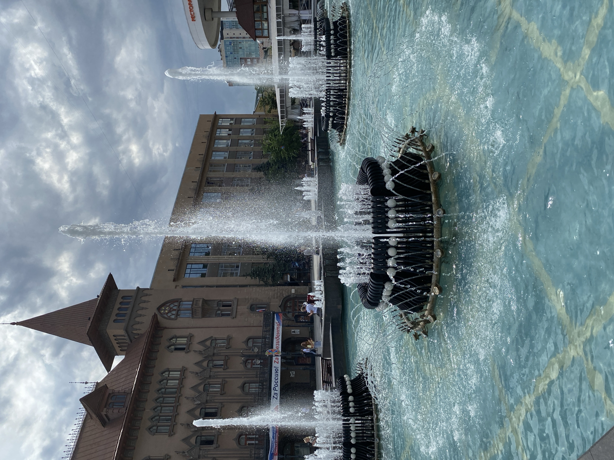 Plaza fountains, riverside lawns, and city streets on a June morning