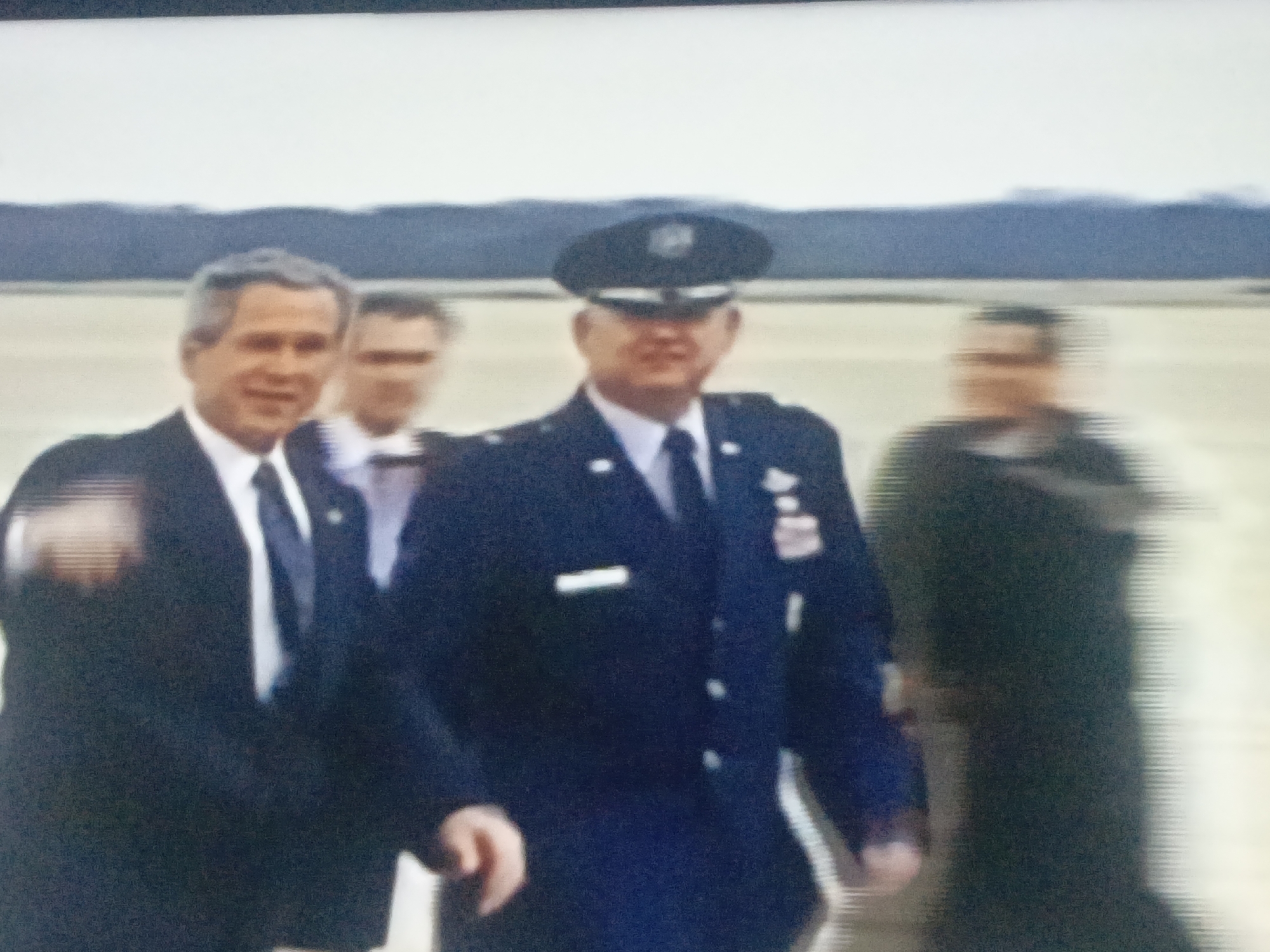 Mixed scenes include Bush, Air Force One, protests in Venezuela