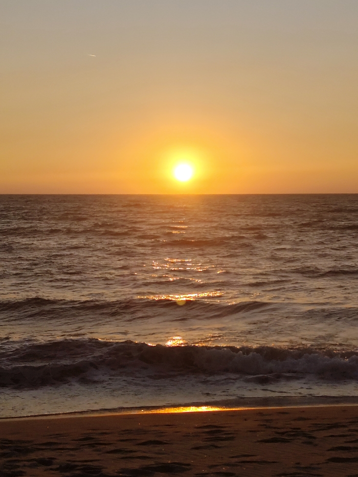 Evening beach life documented at Querim during sunset hours