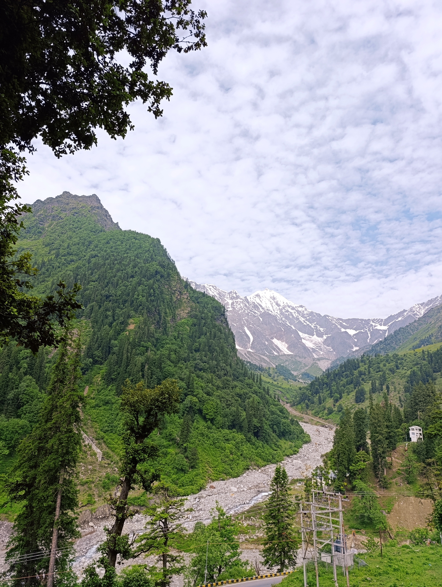 Royal Enfields parked roadside in a Himalayan mountain valley
