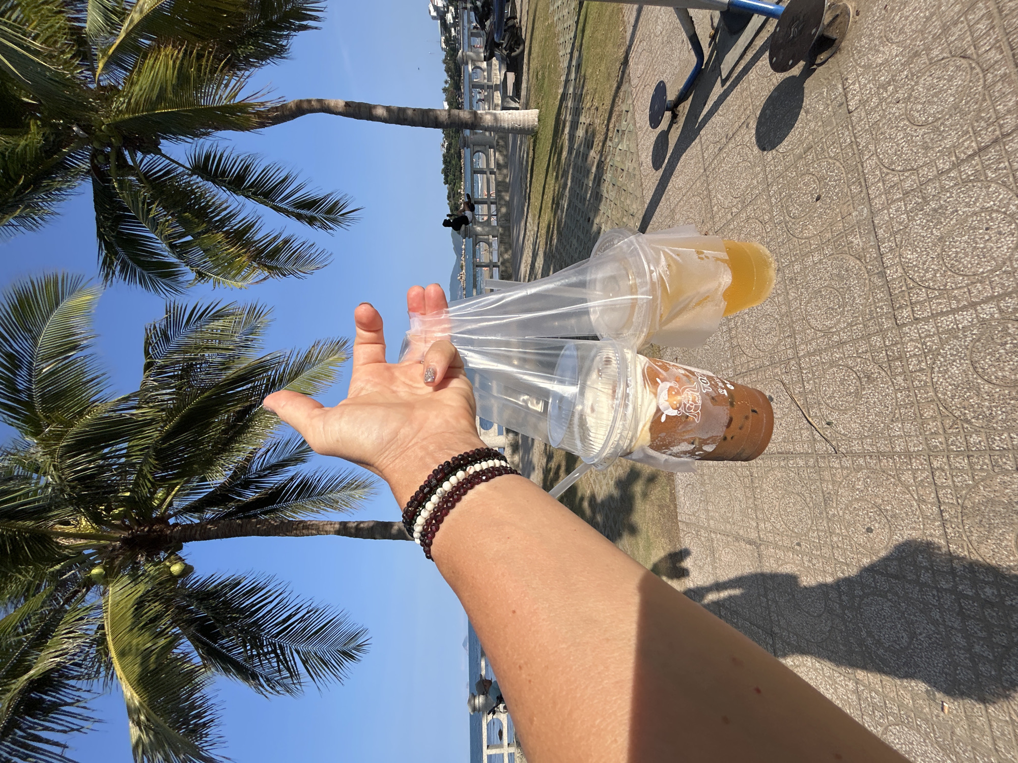 Person carries drinks on Nha Trang street morning