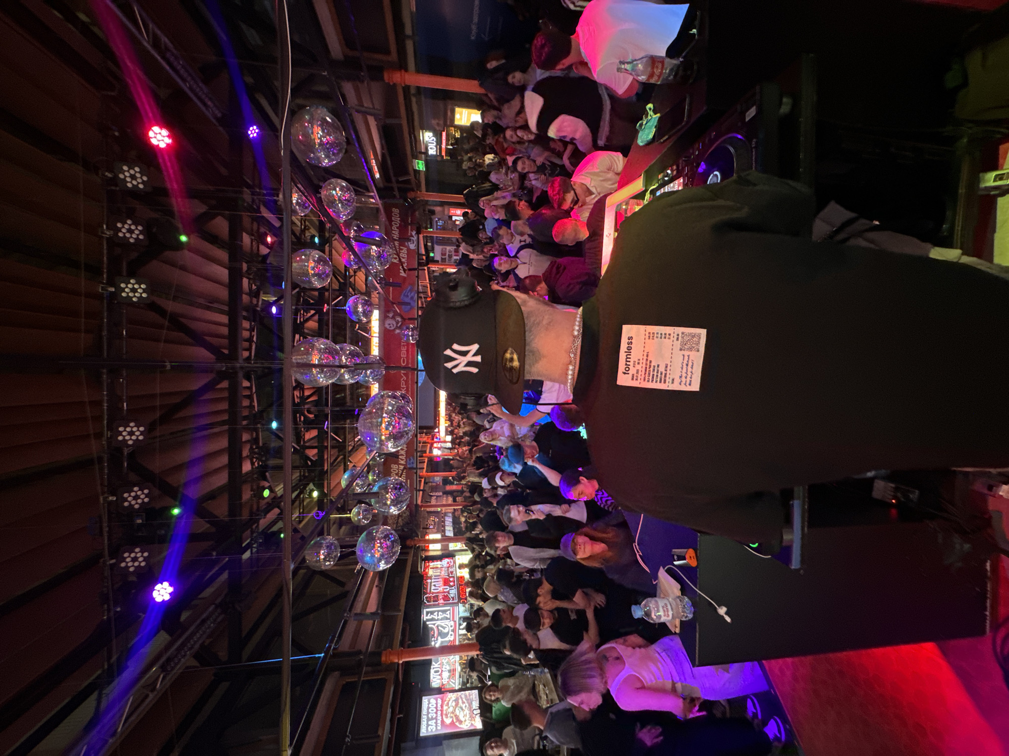 Moscow venue hosts crowded nighttime gathering with disco lighting